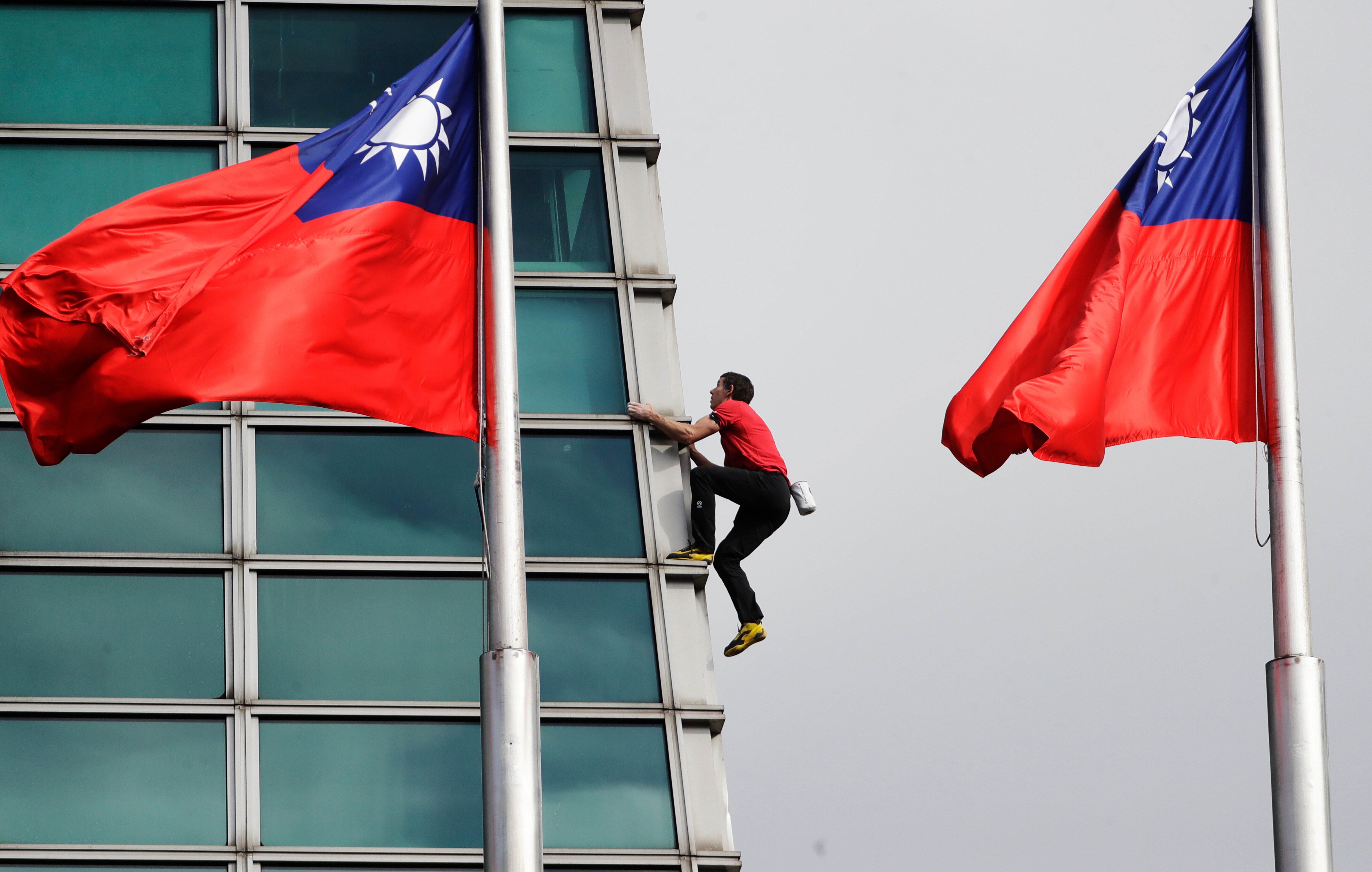 Rock climber Alex Honnold performs a free solo climb of the Taipei 101 skyscraper in Taipei, Taiwan, Sunday