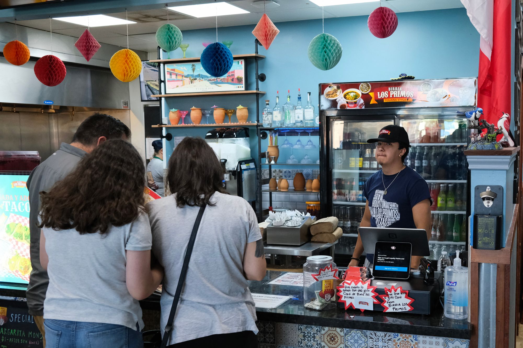 An employee serves customers at a Mexican restaurant in Houston, Texas, in September 2025. Younger employees say they are more likely to work a job just for the paycheck than Gen Xers