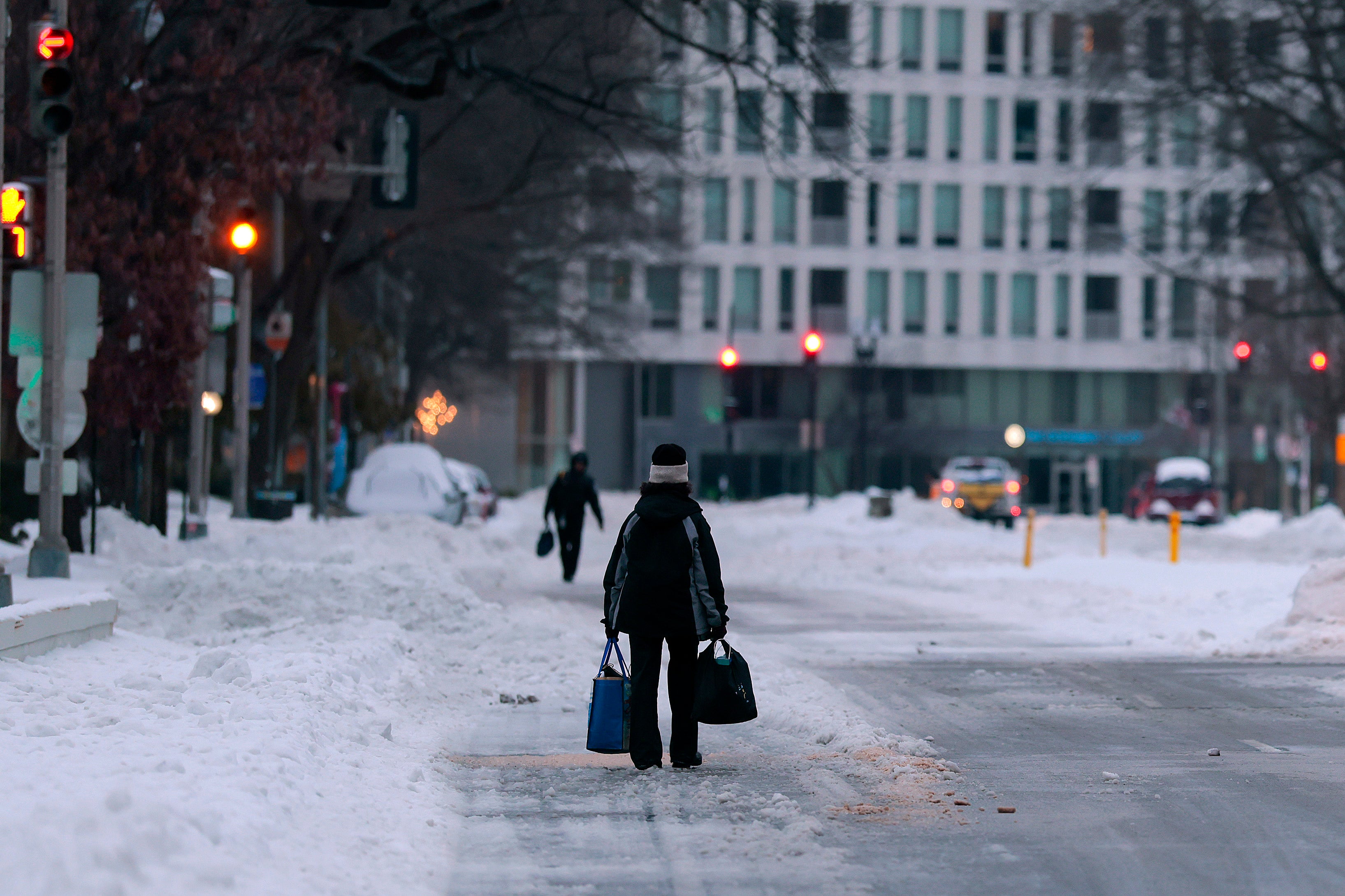 People walk through the snow in Washington, D.C., as some 700,000 remained without power Monday after this weekend’s storm. A second storm is set to hit next weekend, bringing snow to areas already struggling to dig out of snow