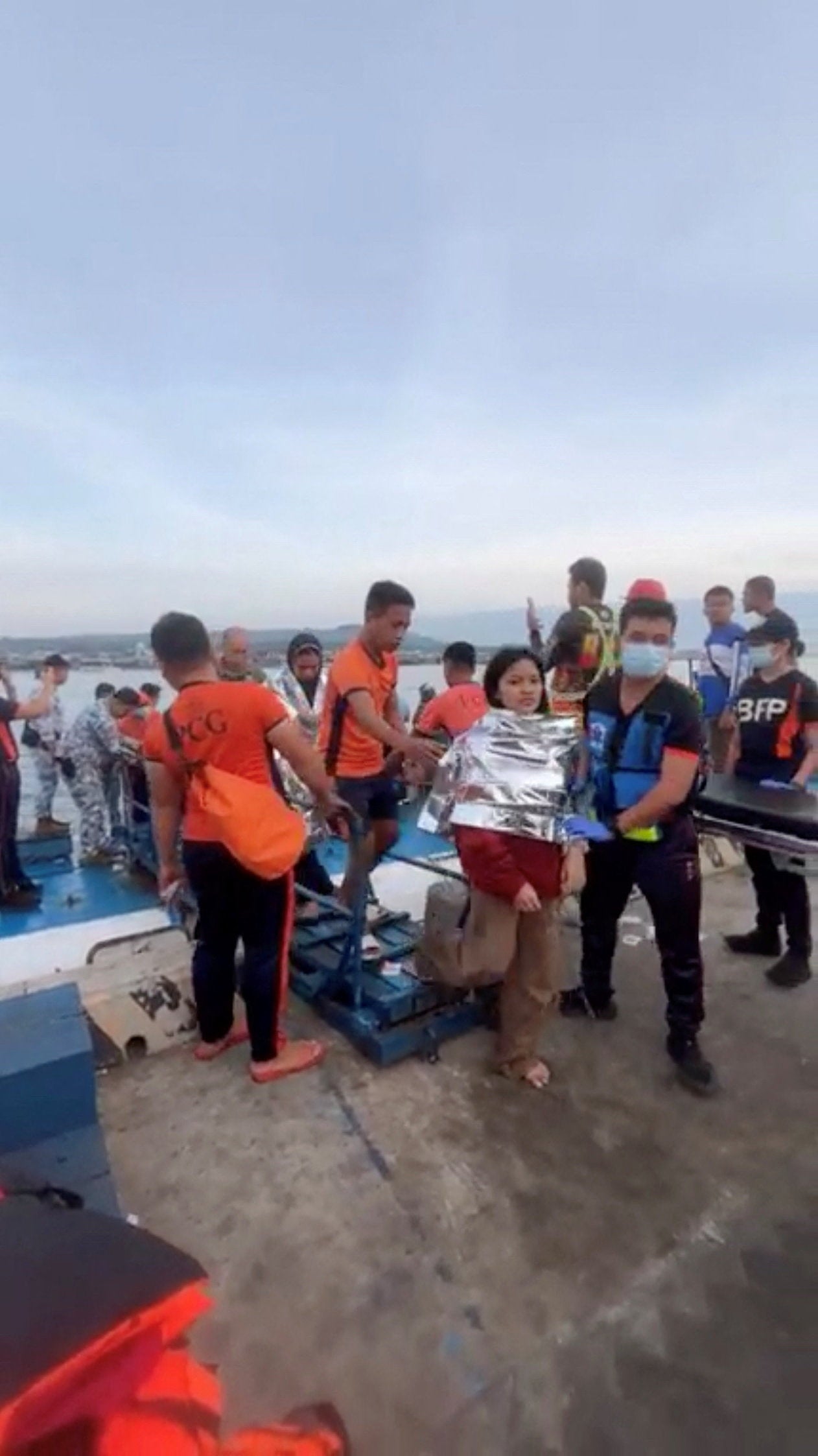 Emergency workers assist victims as they arrive at Isabela Port, Basilan province