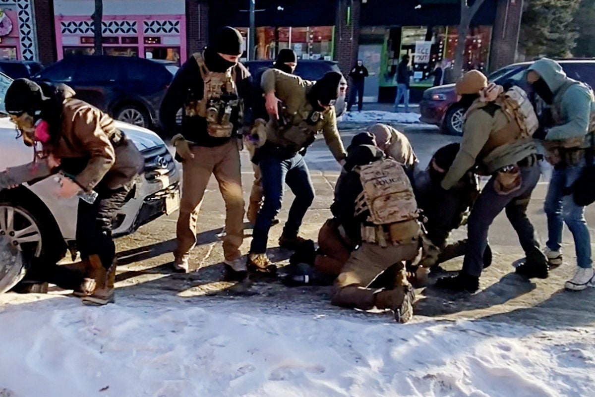 Federal officers surround the stricken Alex Pretti on Minneapolis on Saturday morning
