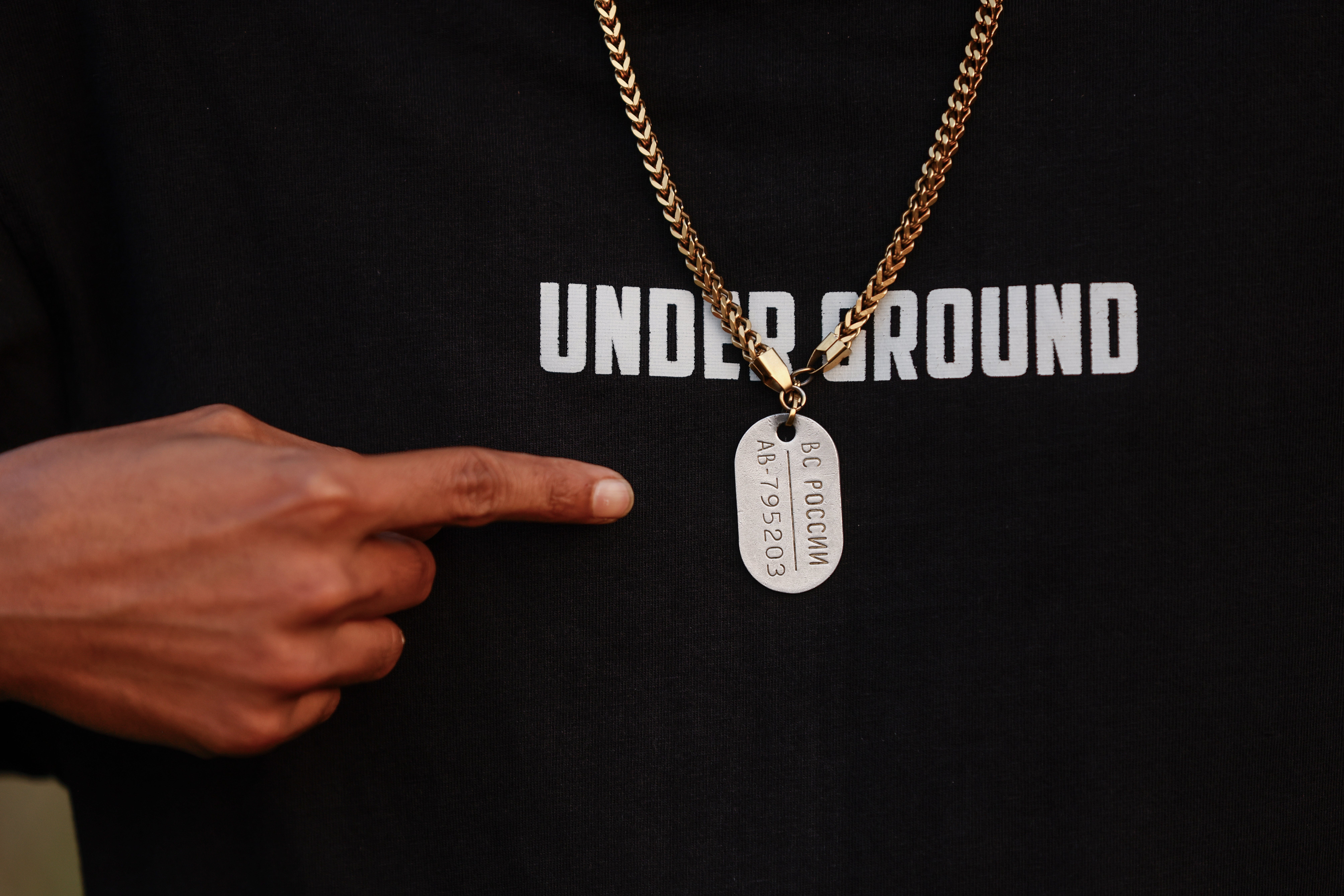 Mohan Miajee, 29, who escaped after fighting for the Russian army, shows his Russian military dog tag in Munshiganj, Bangladesh, Dec. 9, 2025. (AP Photo/Rajib Dhar)