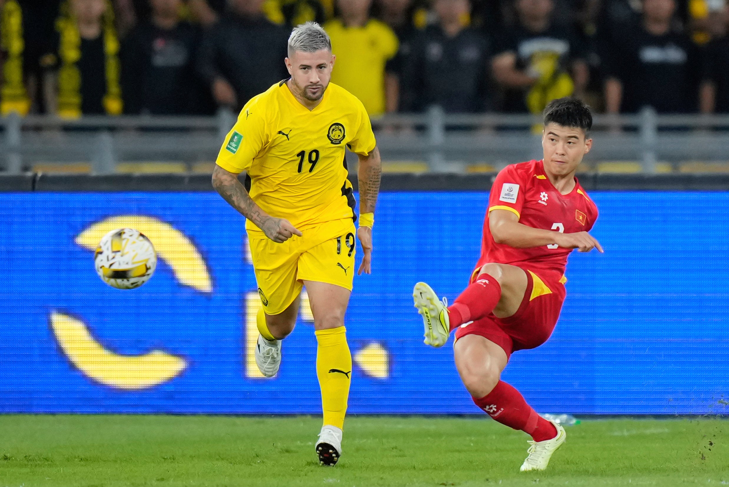 Malaysia's Rodrigo Holgado, left, vies for the ball with Vietnam's Do Duy Manh during the AFC Asian Cup qualifier Group F