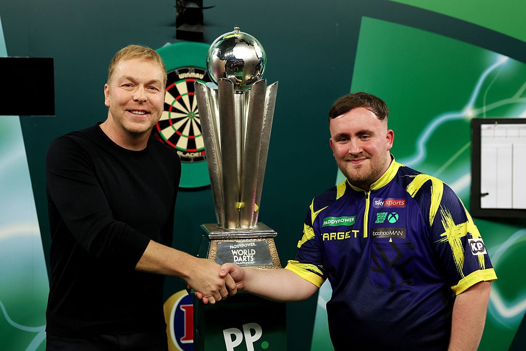 Chris Hoy presents Luke Littler with the World Darts Championship trophy