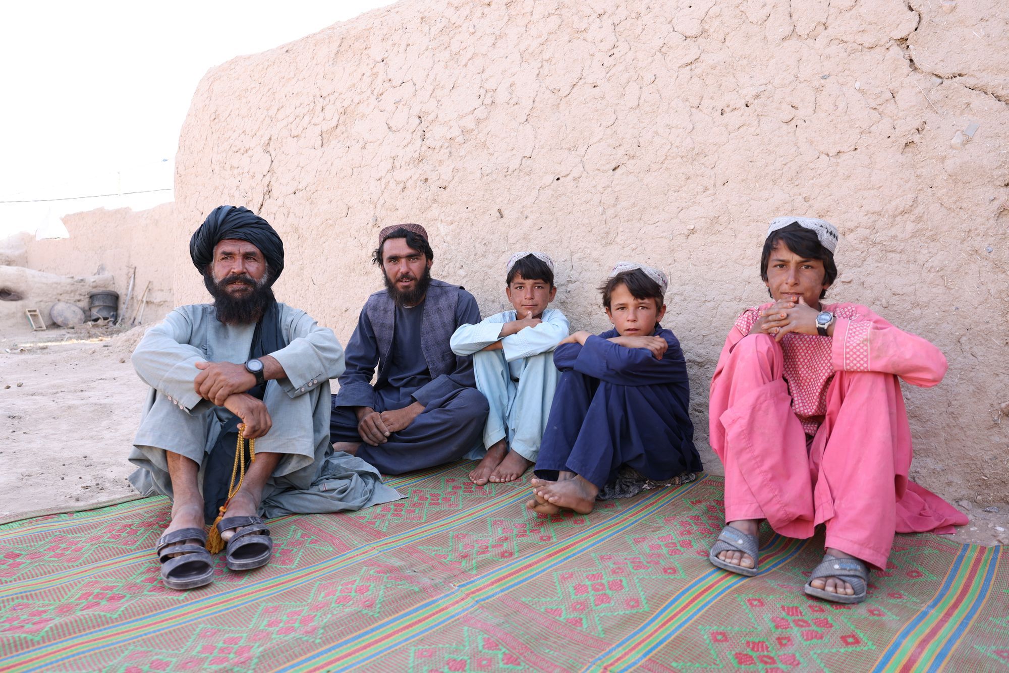Wasiq (left), a 60-year-old farmer sitting with members of his family, describes the drought as a ‘silent killer’