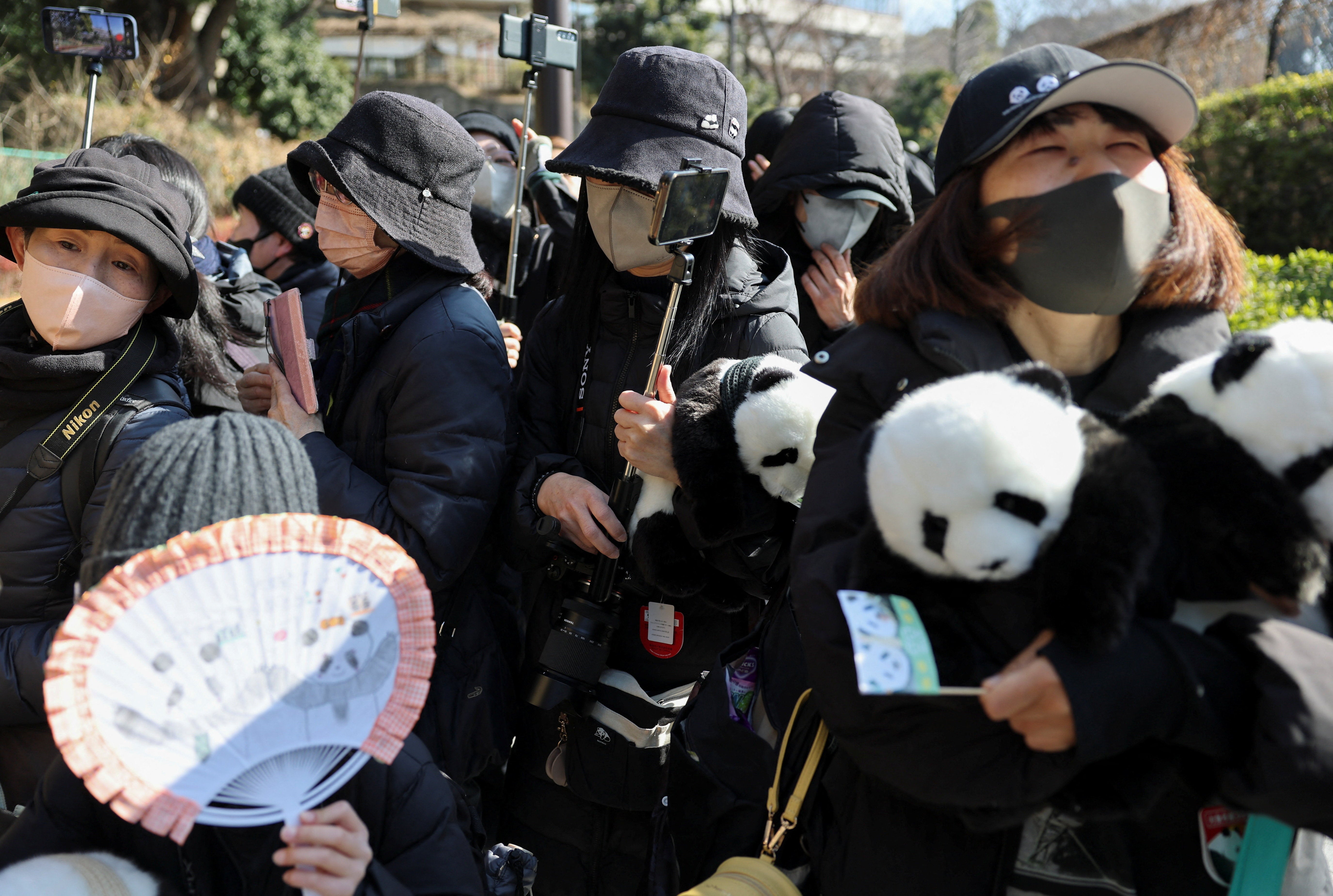 Panda fans gather to see off twin pandas Xiao Xiao and Lei Lei before a truck transporting them departs from Ueno Zoo for their planned return to China