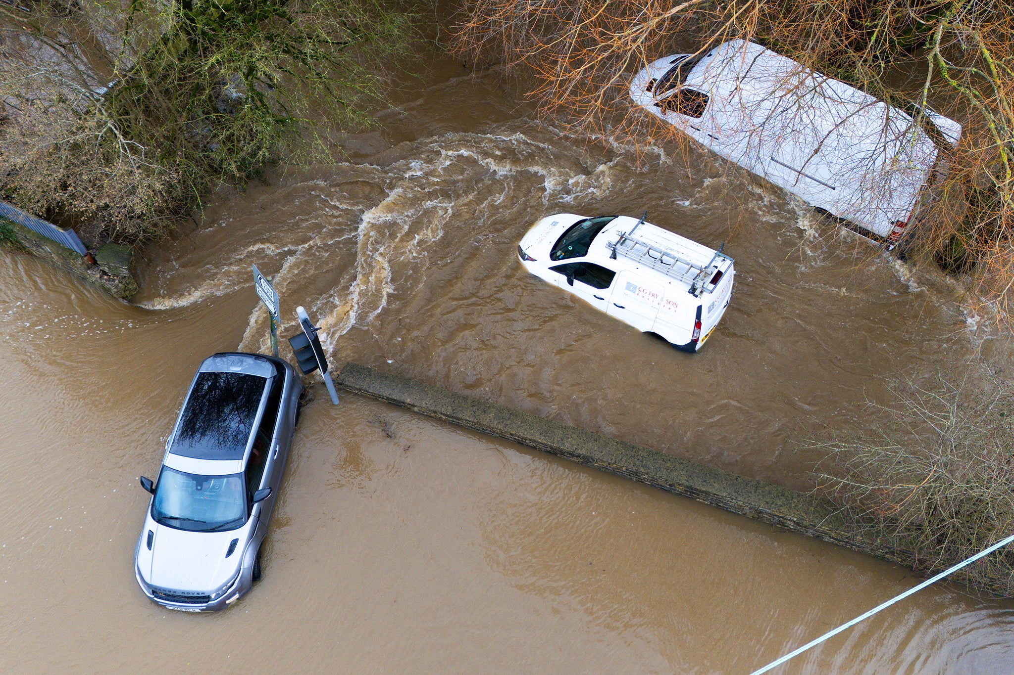 Cars floating in floodwater as rivers burst their banks