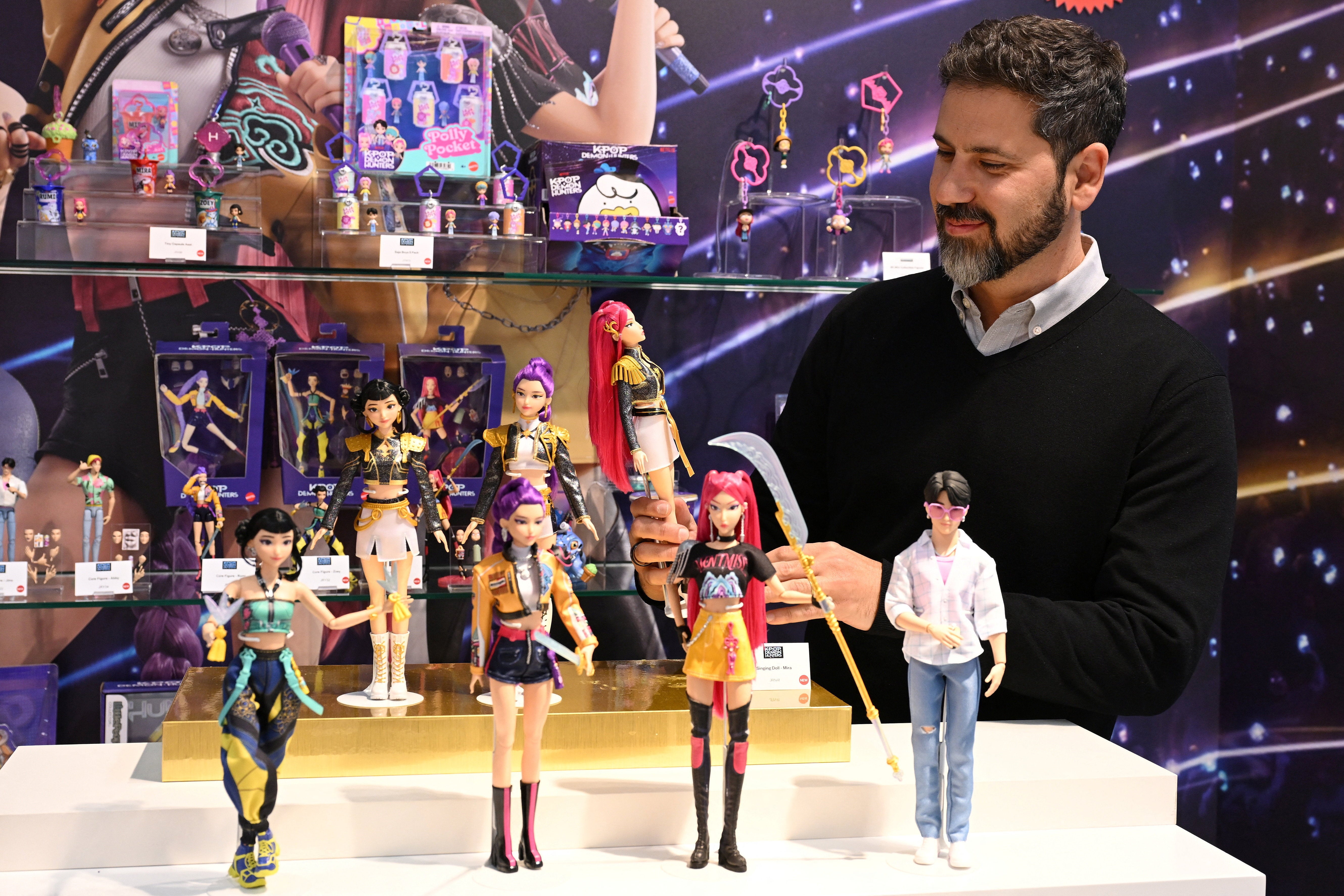 Mattel EVP and Chief Global Brand Officer Roberto Stanichi with the 'KPop Demon Hunters' toys