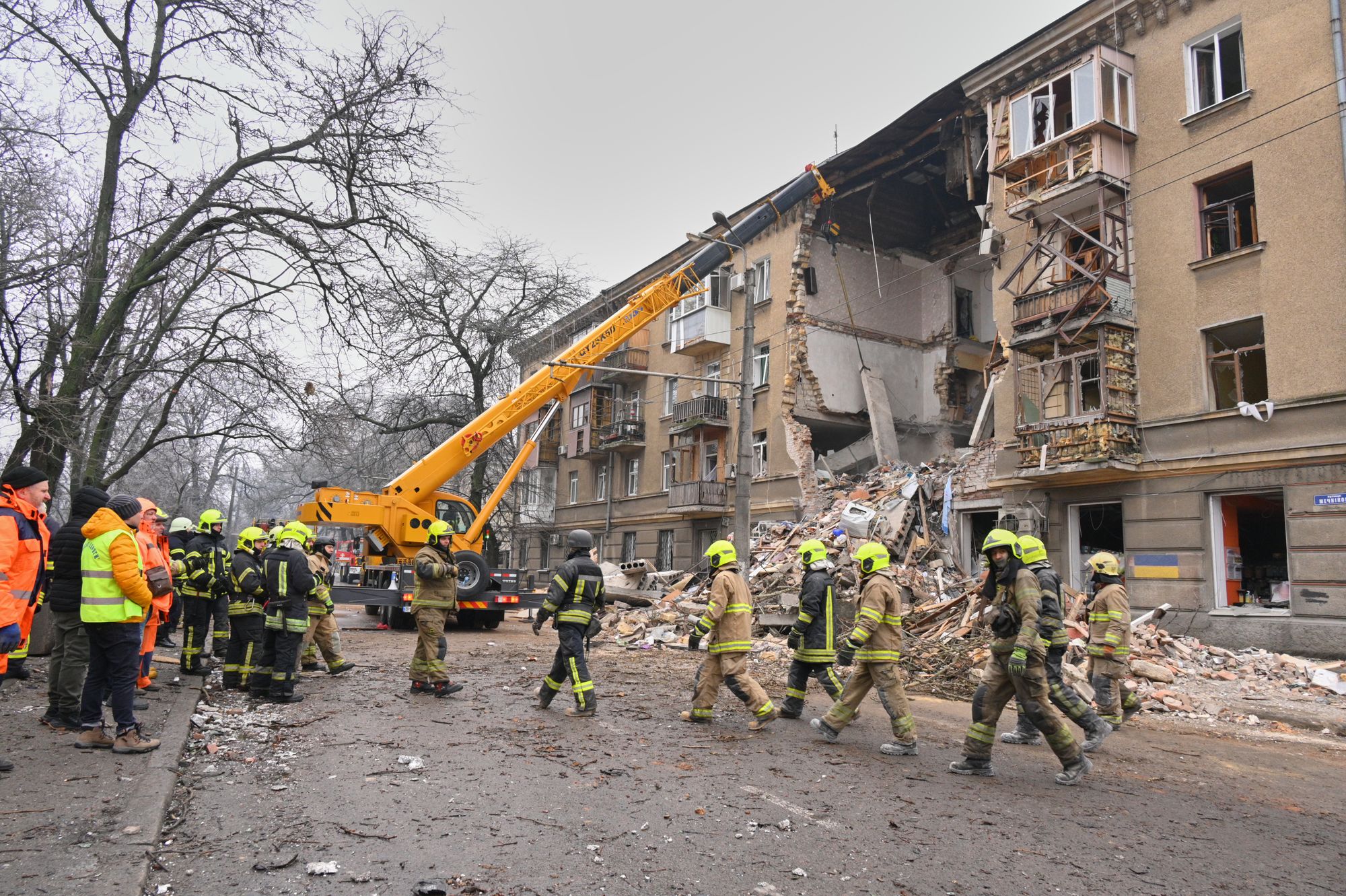 Rescue workers work to clear debris from a residential building, damaged after a Russian strike in Odesa on Tuesday