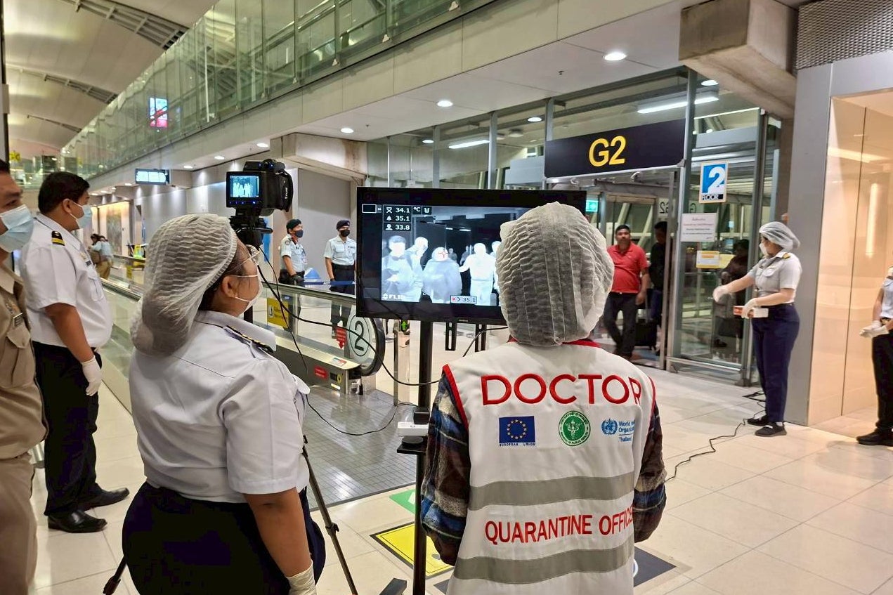 In this photograph provided by the public relations department of the Suvarnabhumi International Airport, Quarantine doctors watch thermal scanning of travelers from west Bengal, India at the Suvarnabhumi International Airport in Samut Prakarn, Thailand, on Sunday, Jan. 25, 2026