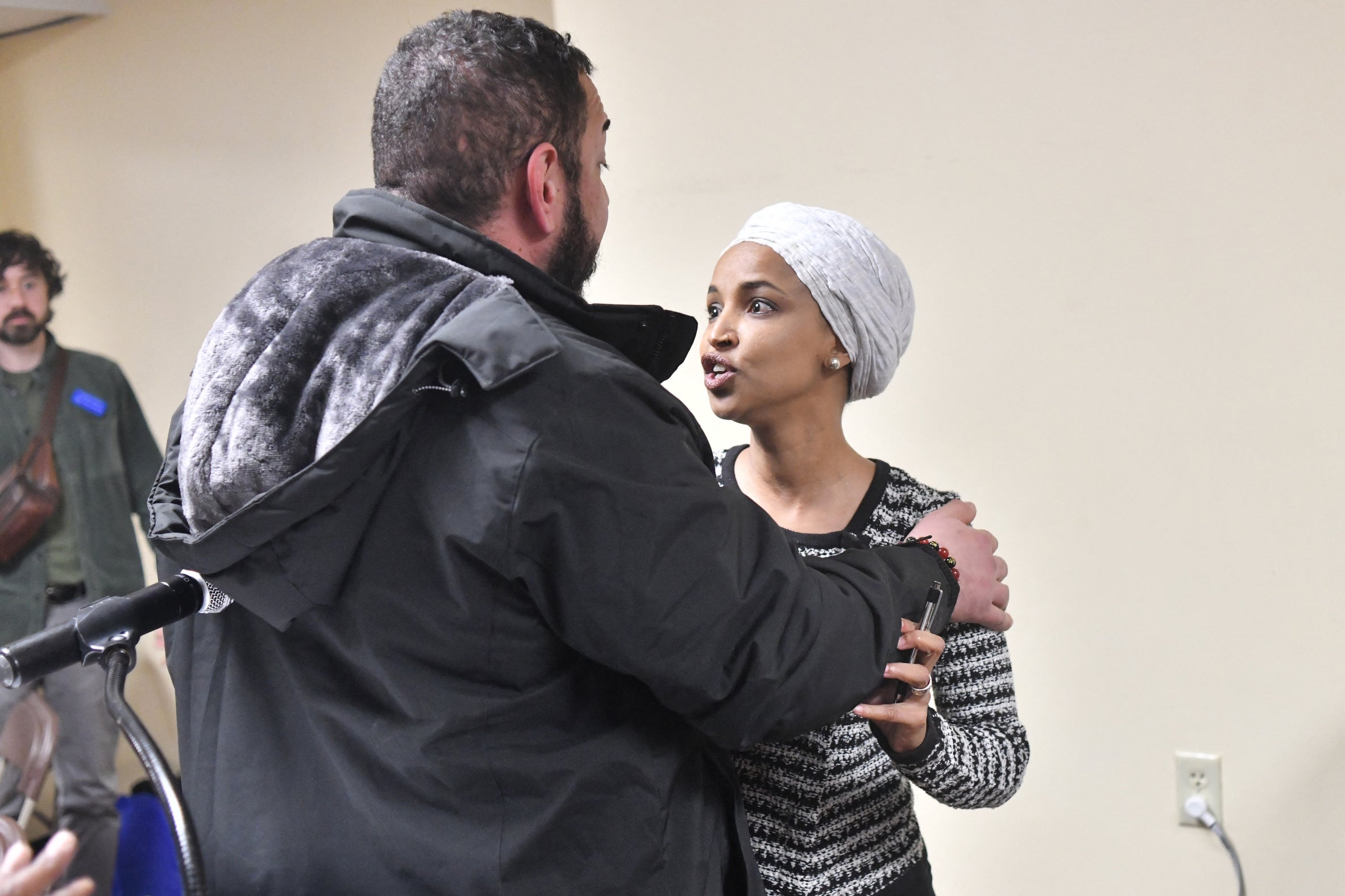 US Representative Ilhan Omar reacts after being sprayed with an unknown substance as she hosted a town hall in Minneapolis, Minnesota.