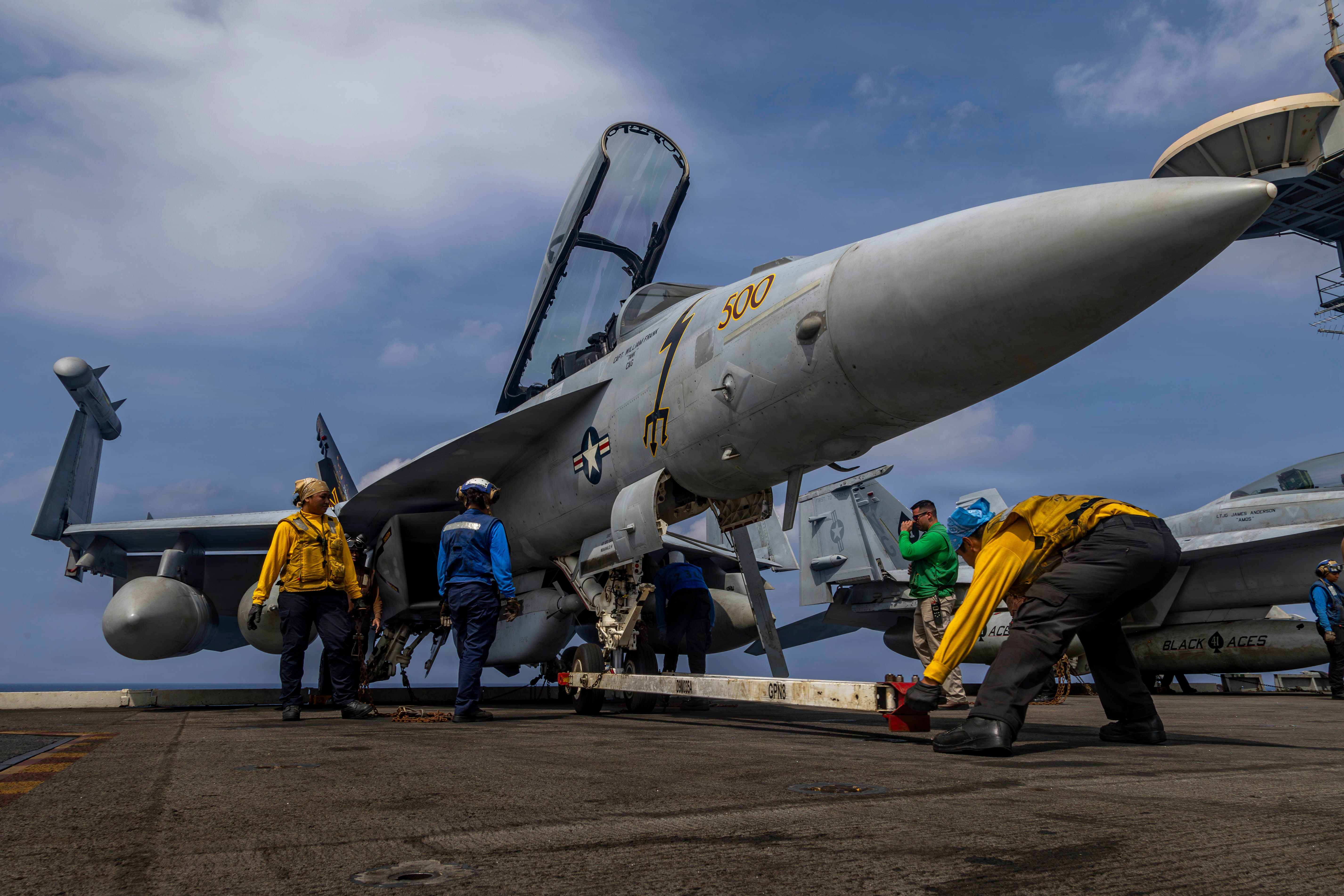 A US fighter jet is prepared on the deck of an aircraft carrier en route to the Middle East