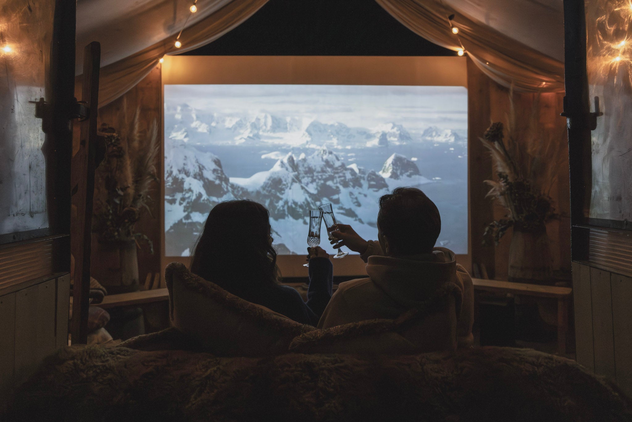 Cosy up in the fairy light-filled barn for a unique cinema experience at Outbuildings