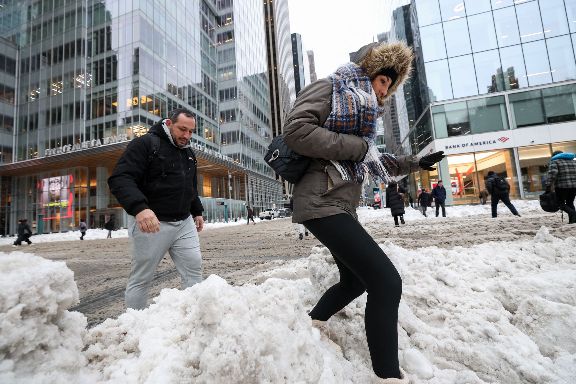 <p>Pedestrians walk through a snow-covered street in New York City on Monday. Forecasters say spring is coming - but faster in some U.S. regions than others</p>