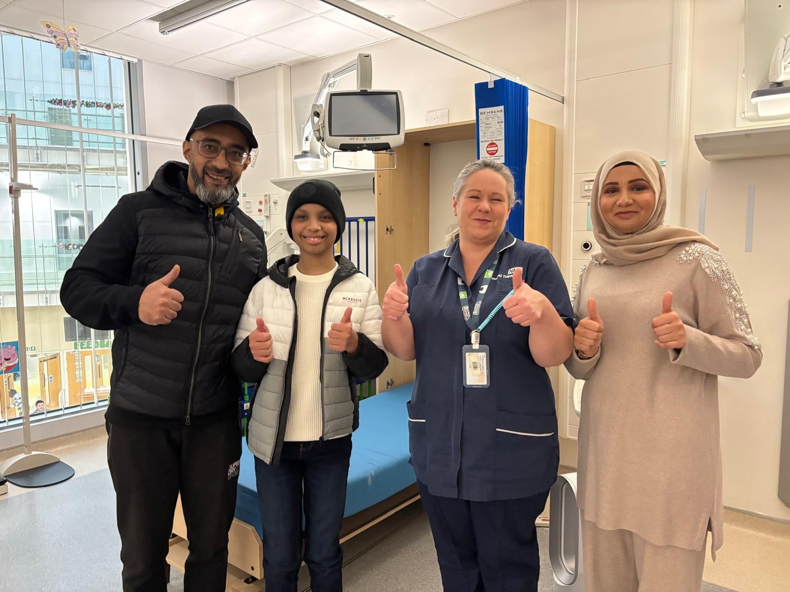 Adam Rehman (second left) returned to the hospital where he underwent treatment