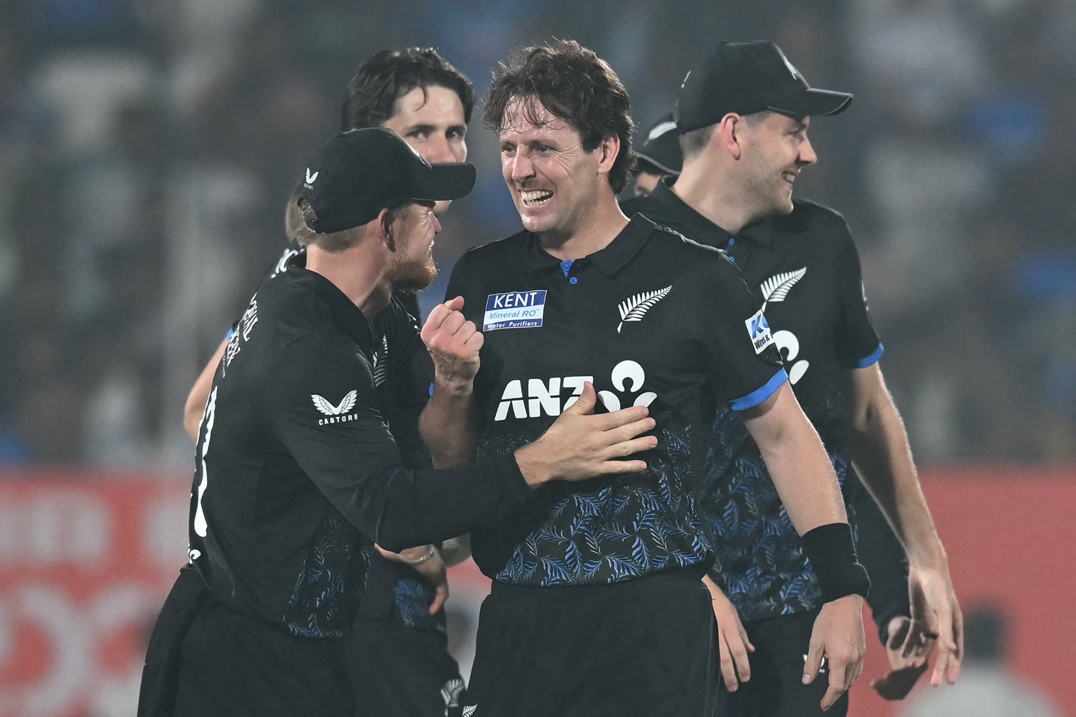 <p>Matt Henry (centre) celebrates after taking the wicket of Shivam Dube</p>