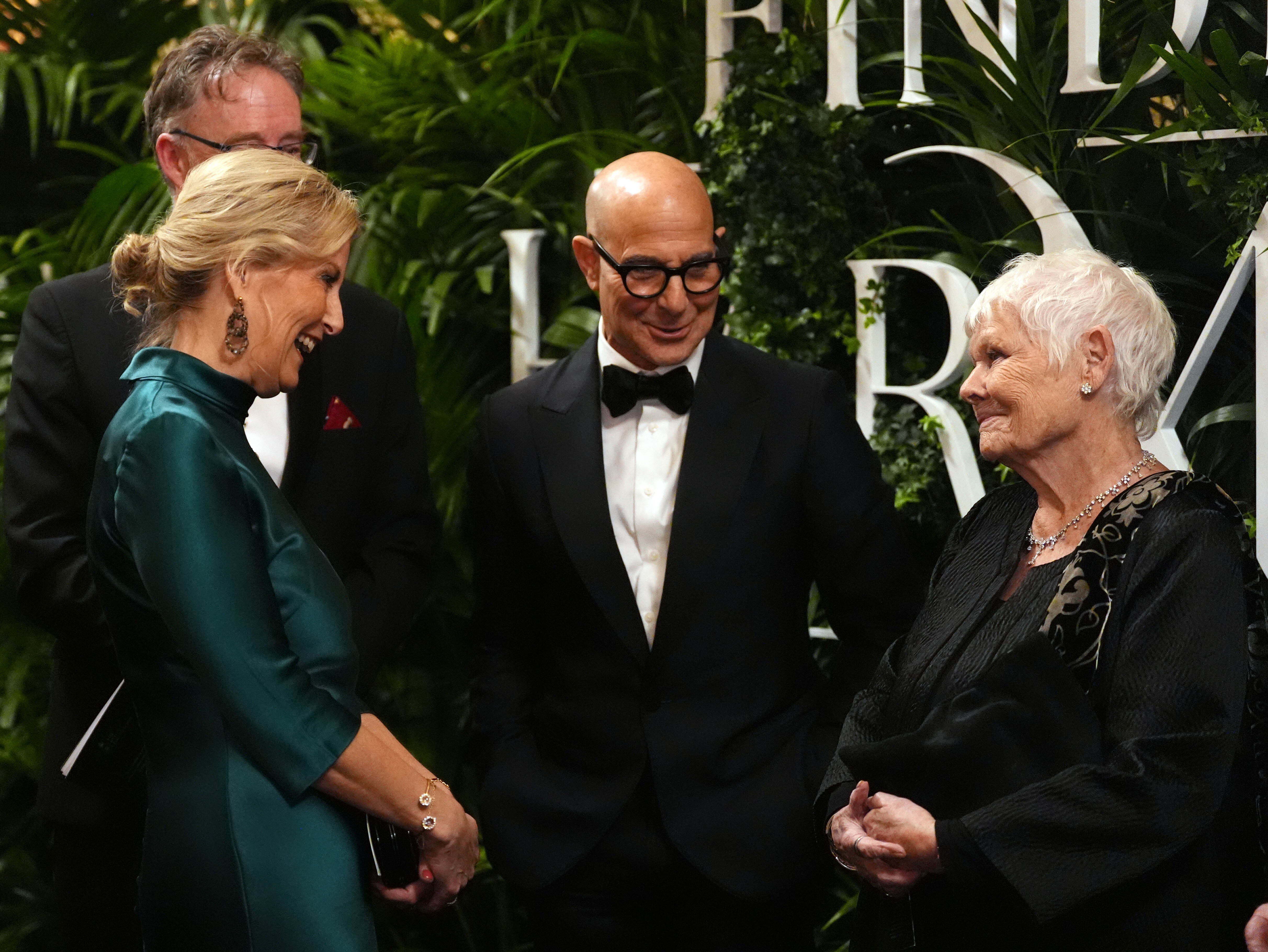 The Duchess of Edinburgh speaks to Stanley Tucci and Dame Judi Dench at the premiere, the first to be held in a royal residence