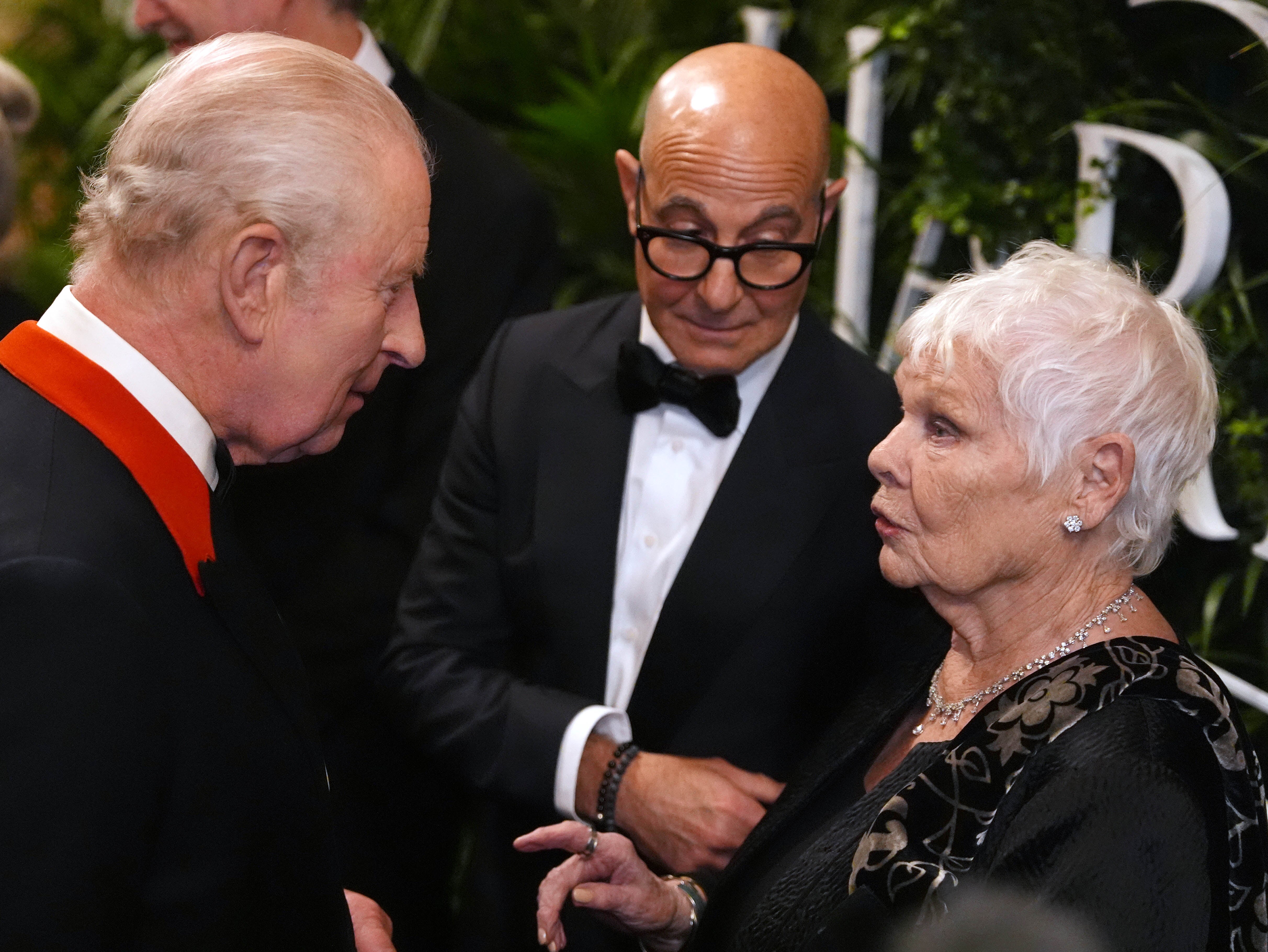 Charles speaks to Stanley Tucci and Dame Judi Dench in the Grand Reception Room after they attended the premiere on Wednesday