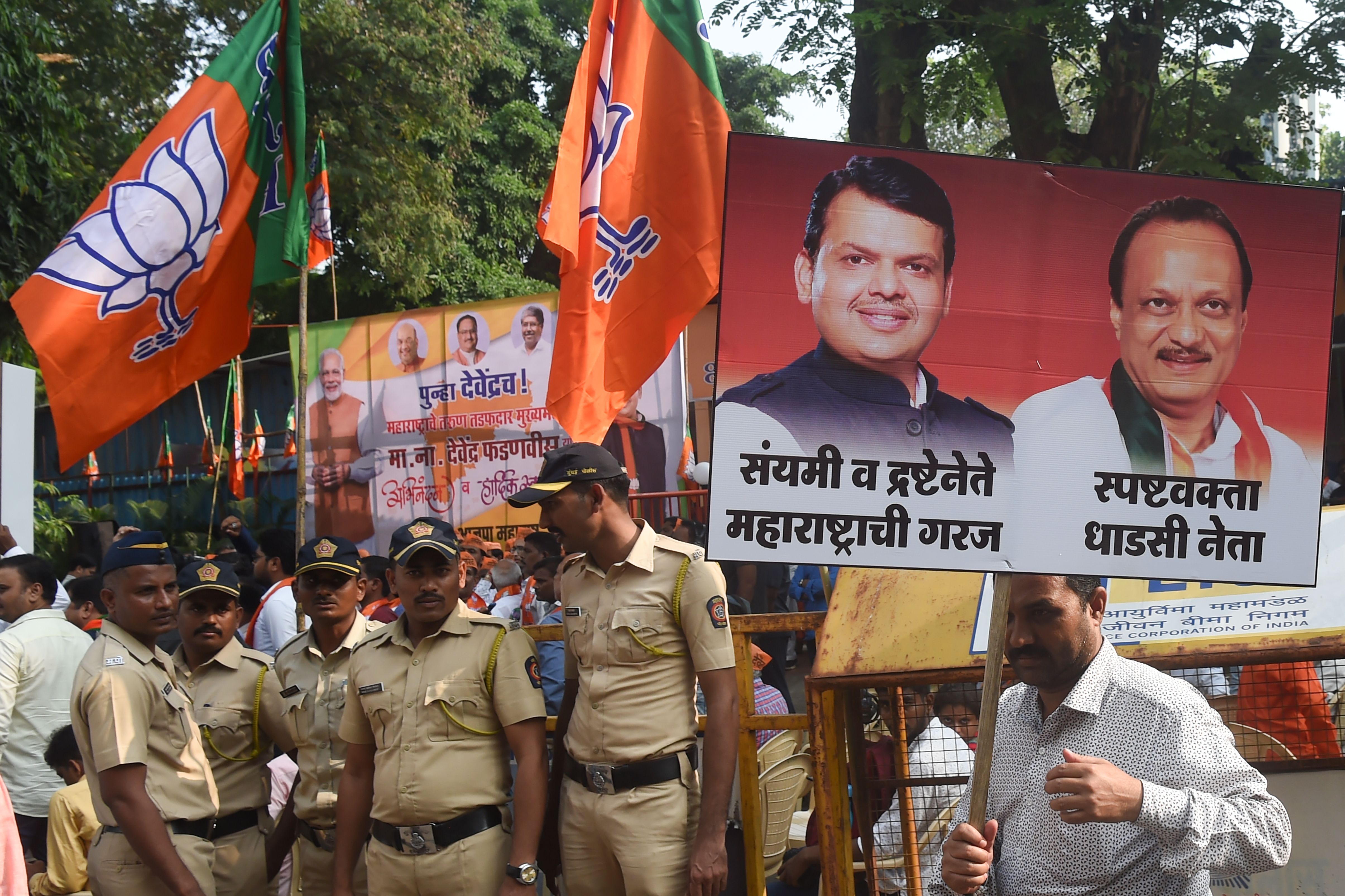 Supporters of Ajit Pawar (right sign) at a victory rally in Mumbai in 2019