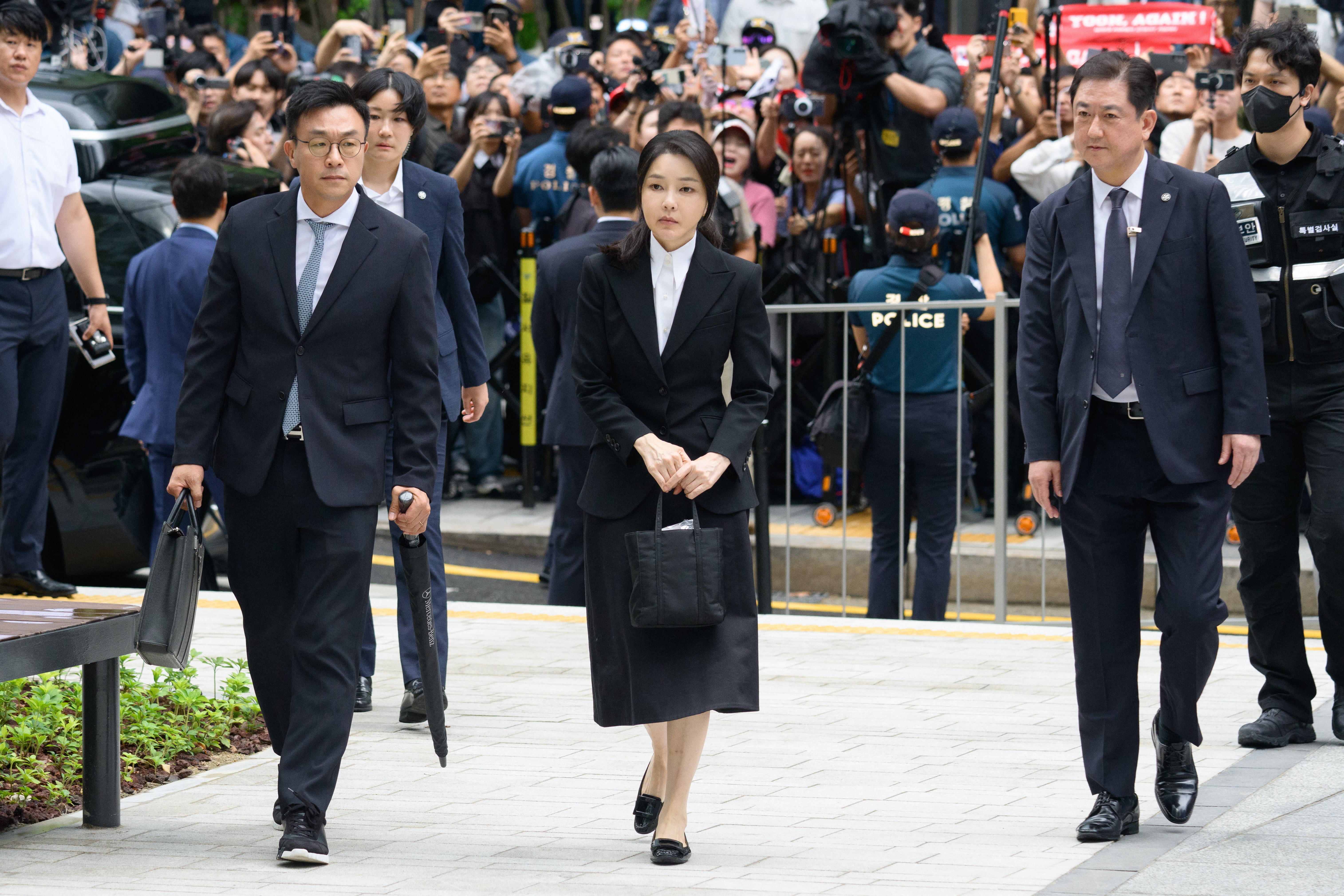 File. South Korea’s former first lady Kim Keon Hee (C), wife of former president Yoon Suk Yeol, arrives at the special prosecutor’s office in Seoul on 6 August 2025. - A South Korean court sentenced former first lady Kim Keon Hee on 28 January 2026, to one year and eight months in prison for corruption