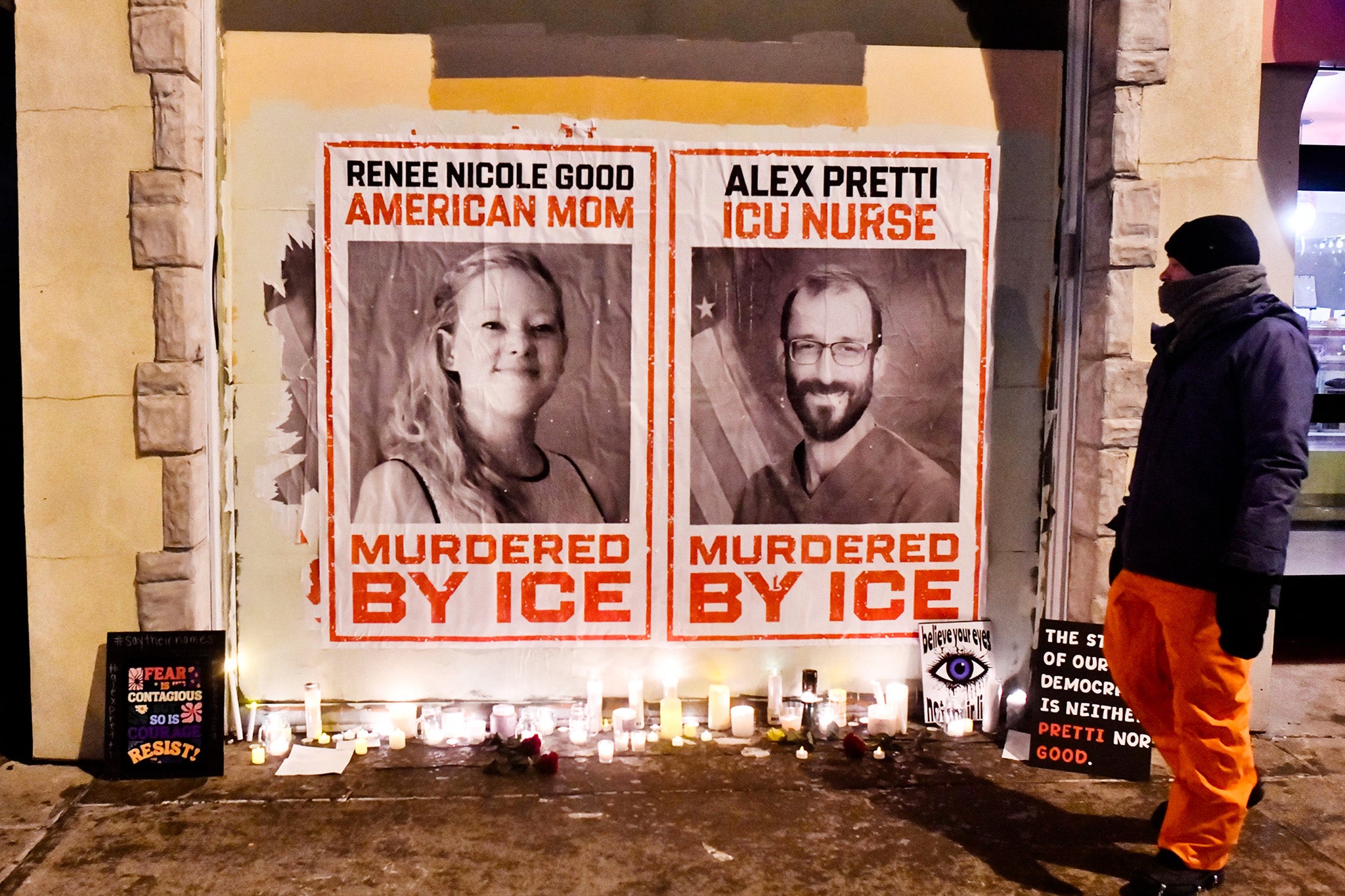 Posters of Renee Good and Alex Pretti, both US citizens fatally shot by immigration agents, are seen during a candlelight vigil in Minneapolis
