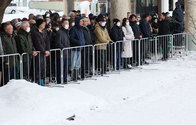 <p>Voters listen to a party leader's speech at a House of Representatives election rally held in a snow-covered venue in Hirosaki, Aomori Prefecture</p>
