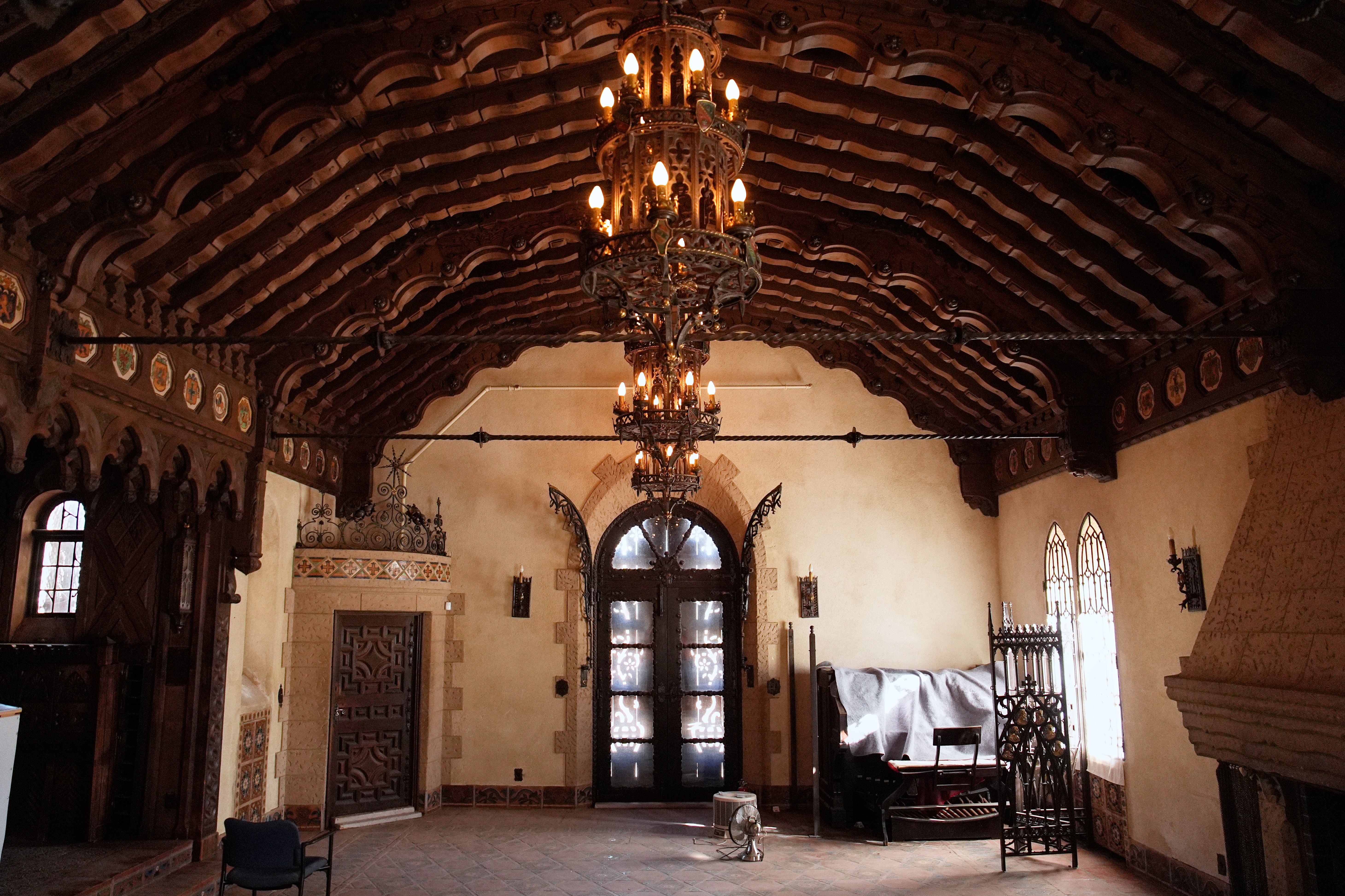 Chandeliers illuminate a room inside Scotty’s Castle
