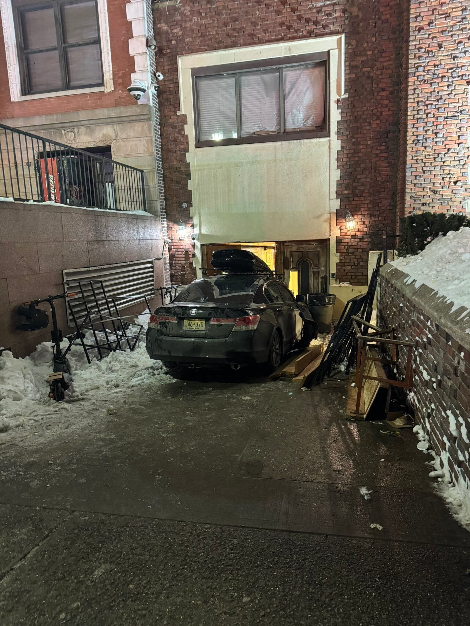 This photo provided by Rabbi Yaacov Behrman shows a car that crashed into the Chabad Lubavitch world headquarters in New York City, late Wednesday, Jan.28, 2026