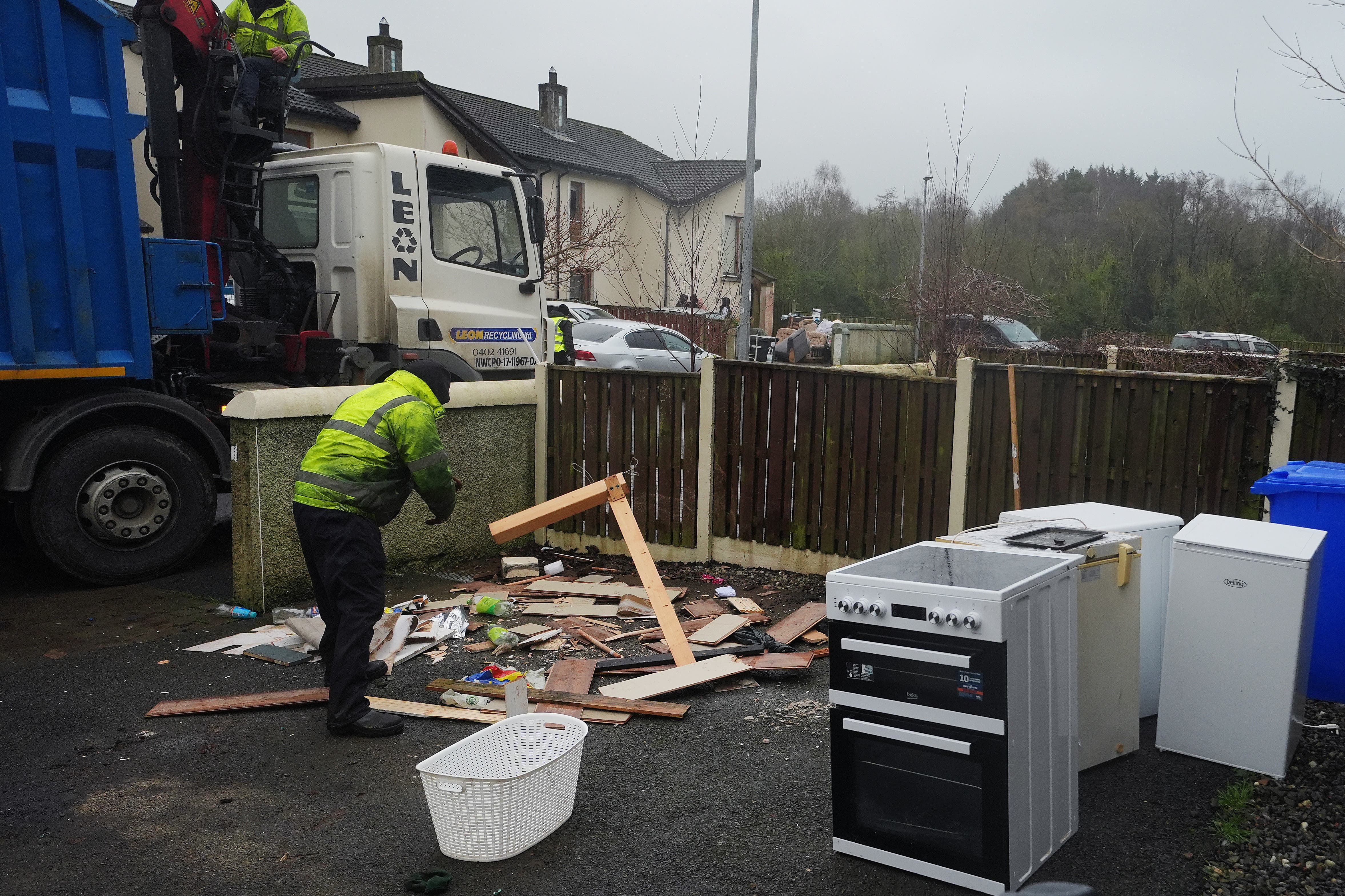 Workers clear damaged items from residents gardens in Riverfield in Aughrim, Co Wicklow (Brian Lawless/PA)