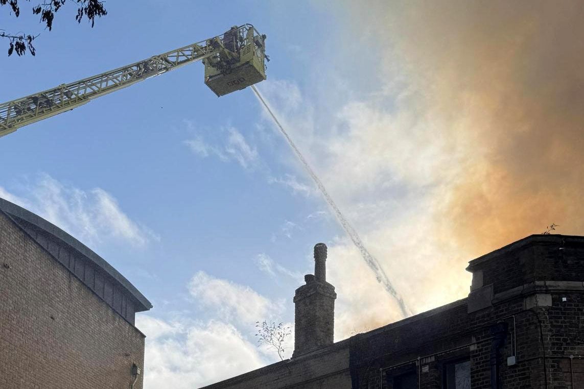<p>Firefighters are tackling a blaze near the railway line in Camden</p>