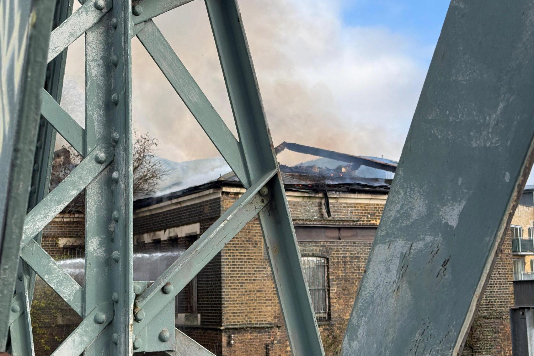 Firefighters are tackling the blaze near the railway line in Camden