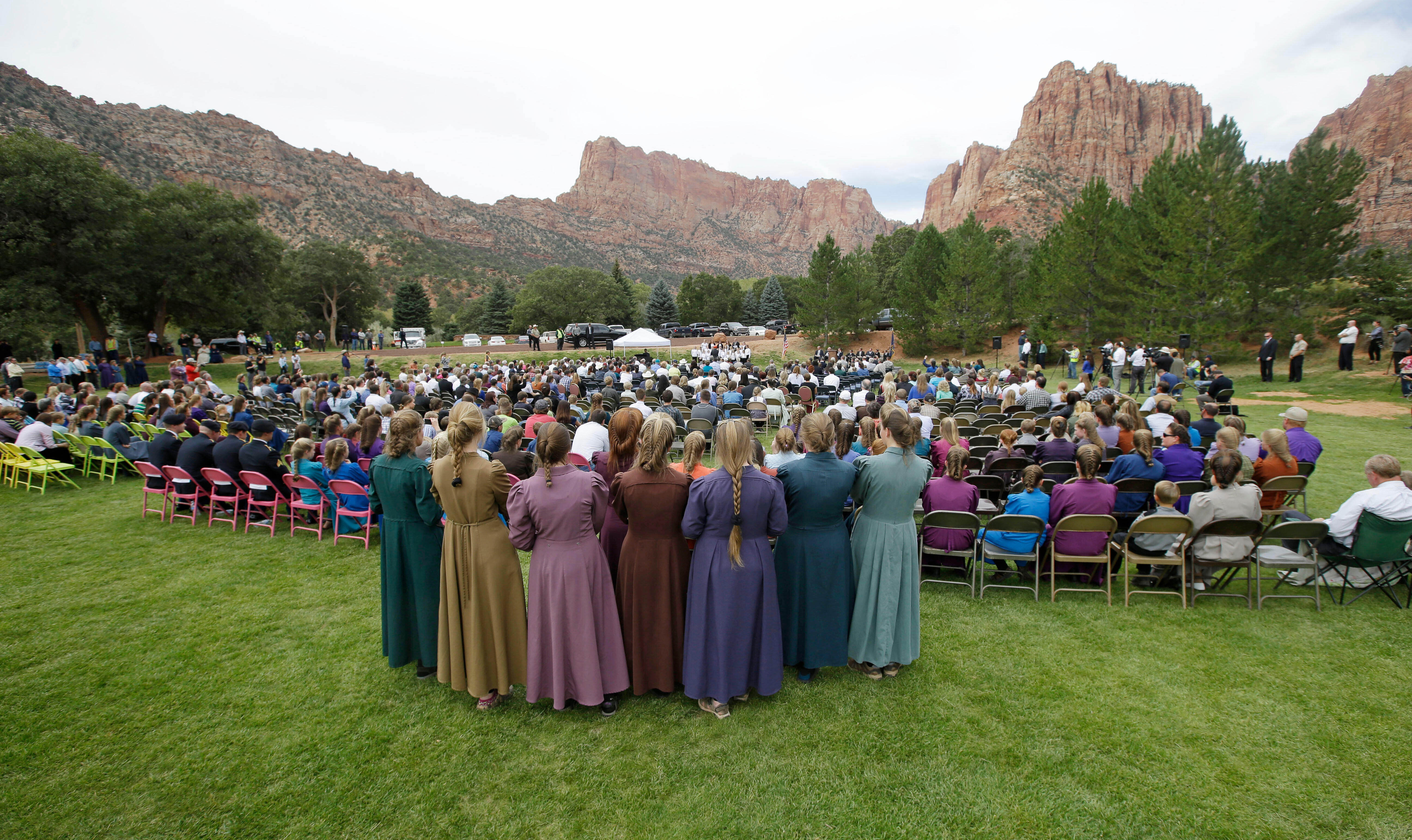 Two polygamous towns on the Utah-Arizona border hold a public memorial for women and children swept away in a deadly flash flood