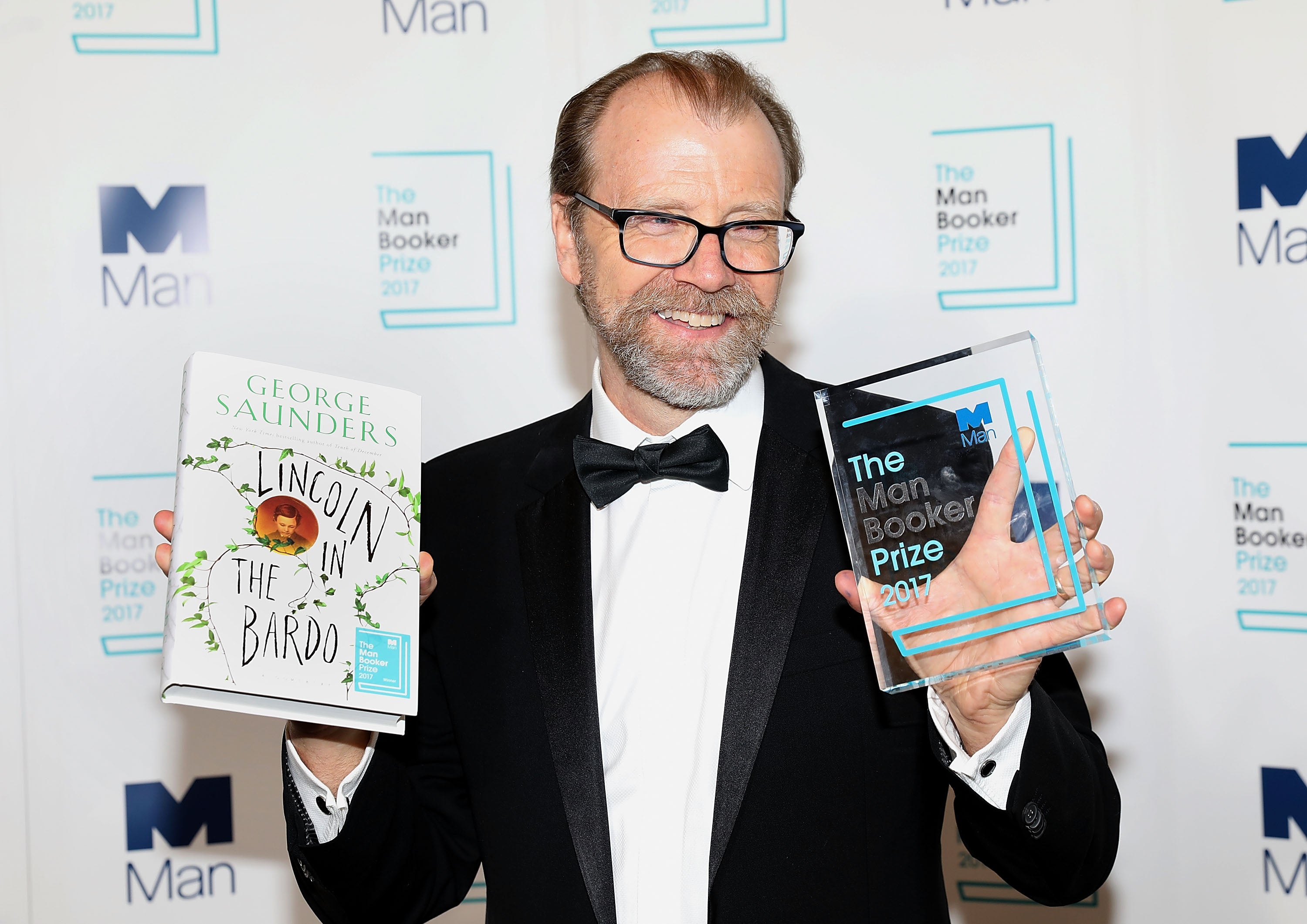 All smiles: Saunders poses with his Booker Prize-winning book ‘Lincoln in the Bardo’ in 2017
