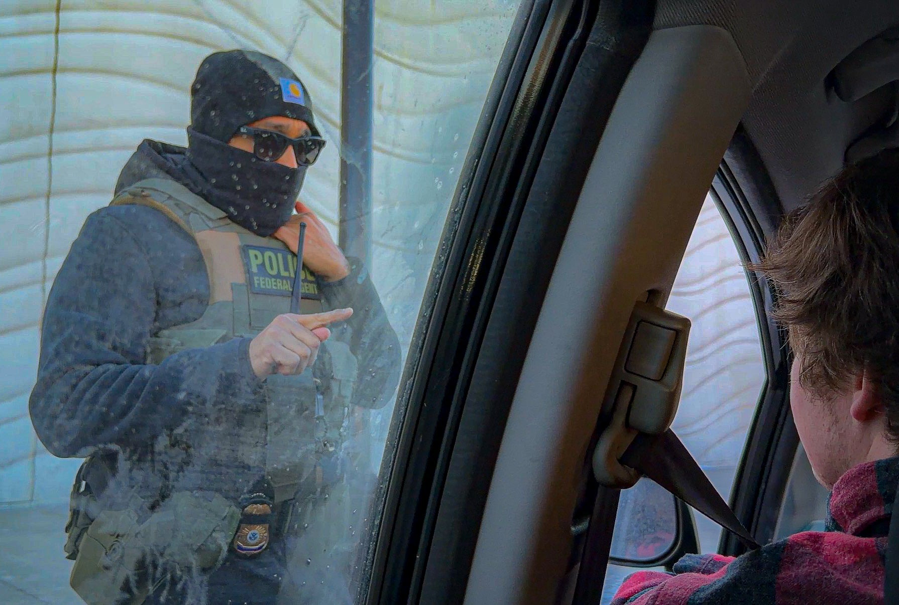 An ICE agent threatens a volunteer with arrest if they keep following his car amid a violent crackdown in Minneapolis