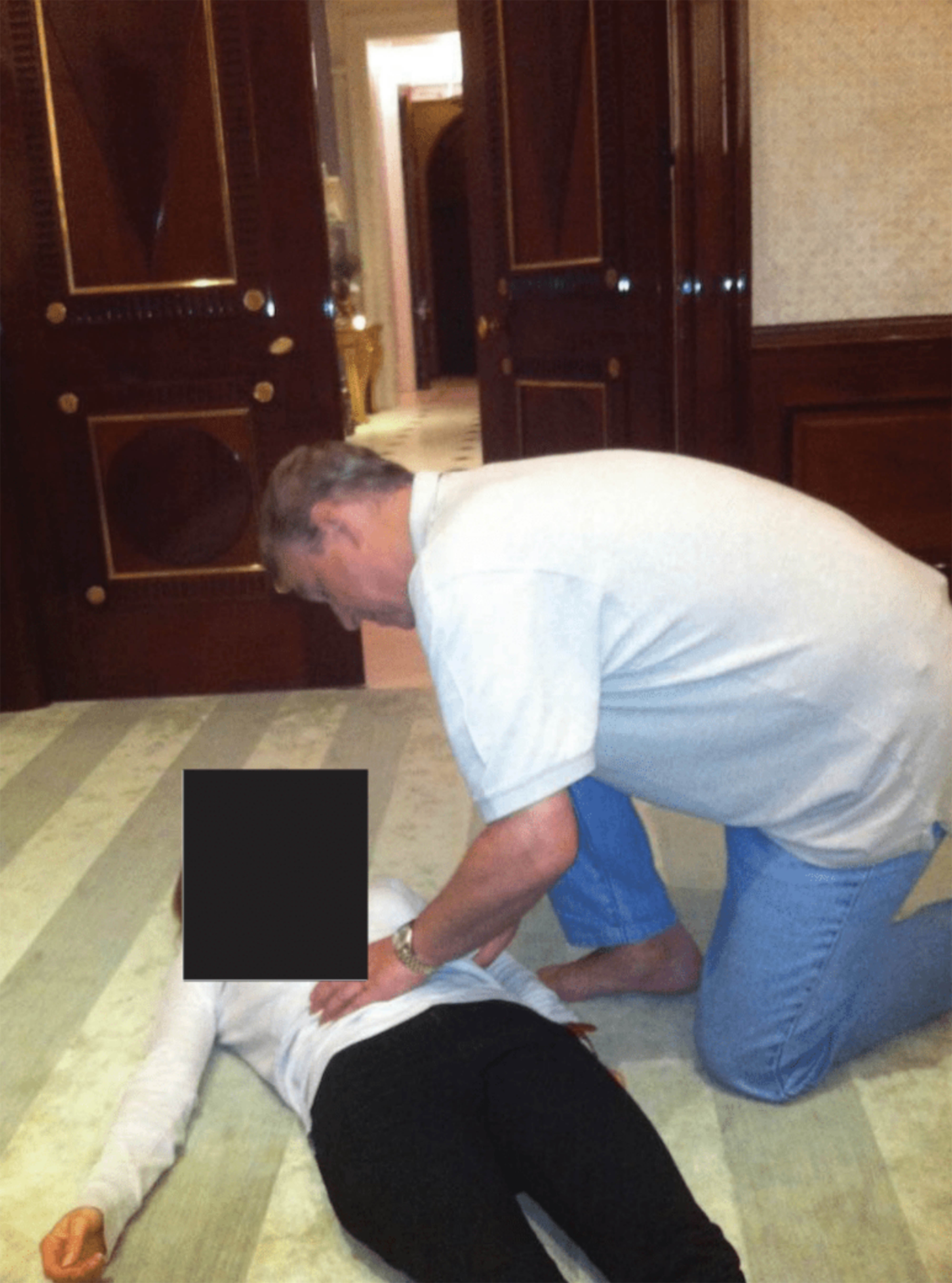 Andrew appears to touch a woman's abdomen in a picture released in the Epstein files