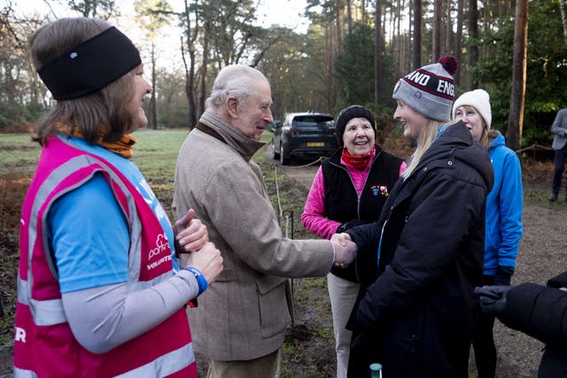 <p>Charles and volunteer Sarah Byatt (left) speak to members of the Sandringham parkrun</p>