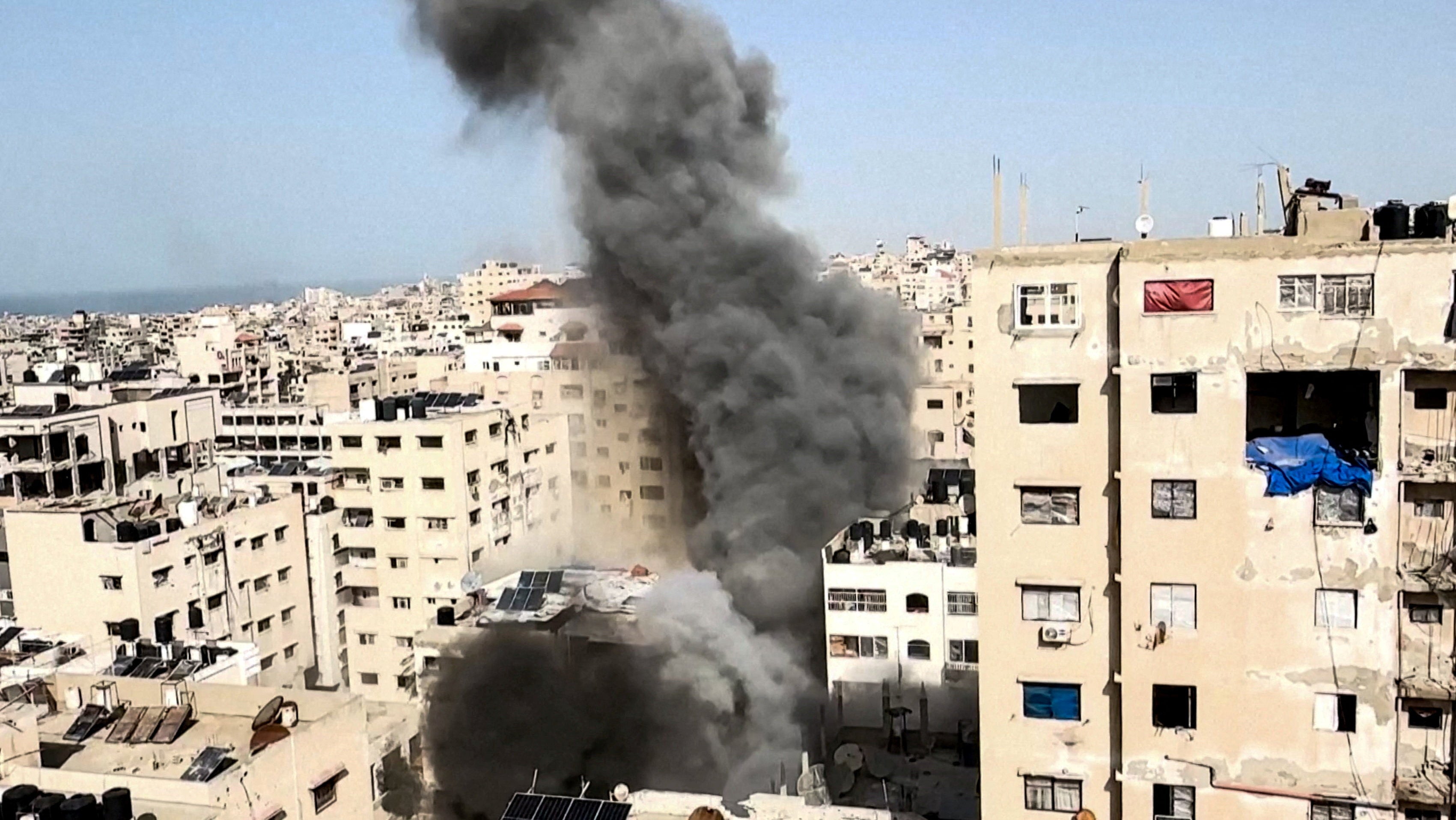 Smoke rises after a projectile fell on a building in Gaza City on Saturday