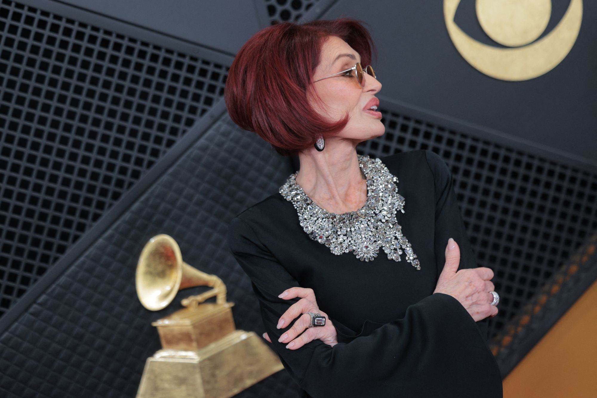 To accessorize, Osbourne chose a stunning diamond ring, matching earrings, and yellow sunglasses. She also had her signature short dark red hair parted to the side