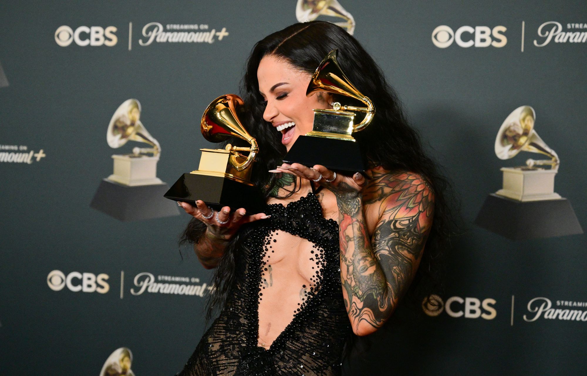 The singer (seen posing with the two Grammy Awards she won earlier in the evening; one for Best R&B Performance and another for Best R&B Song) had her arm and neck tattoos on full display