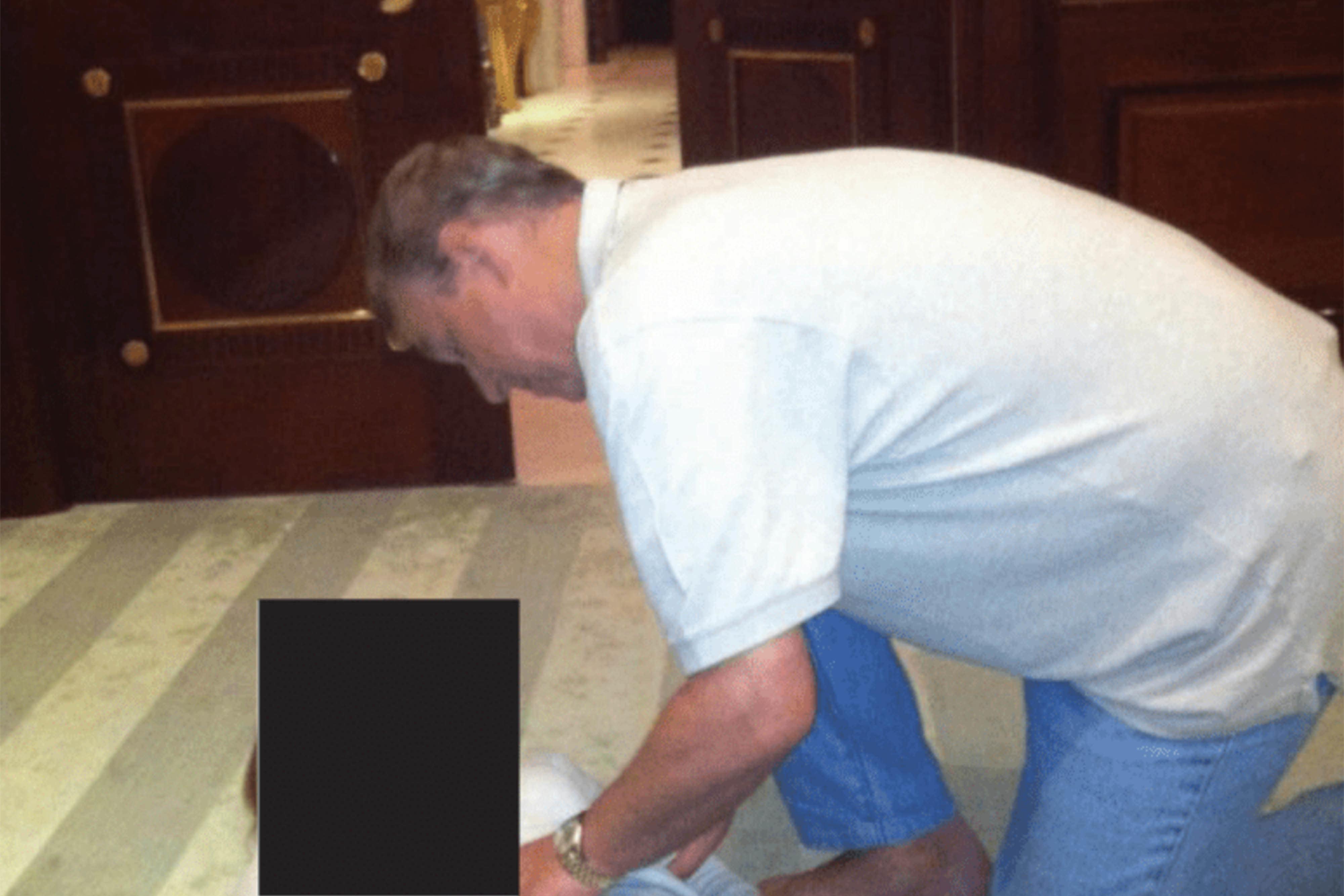 Photos appearing to show Andrew crouched over an unidentified woman were included in the latest Epstein files release