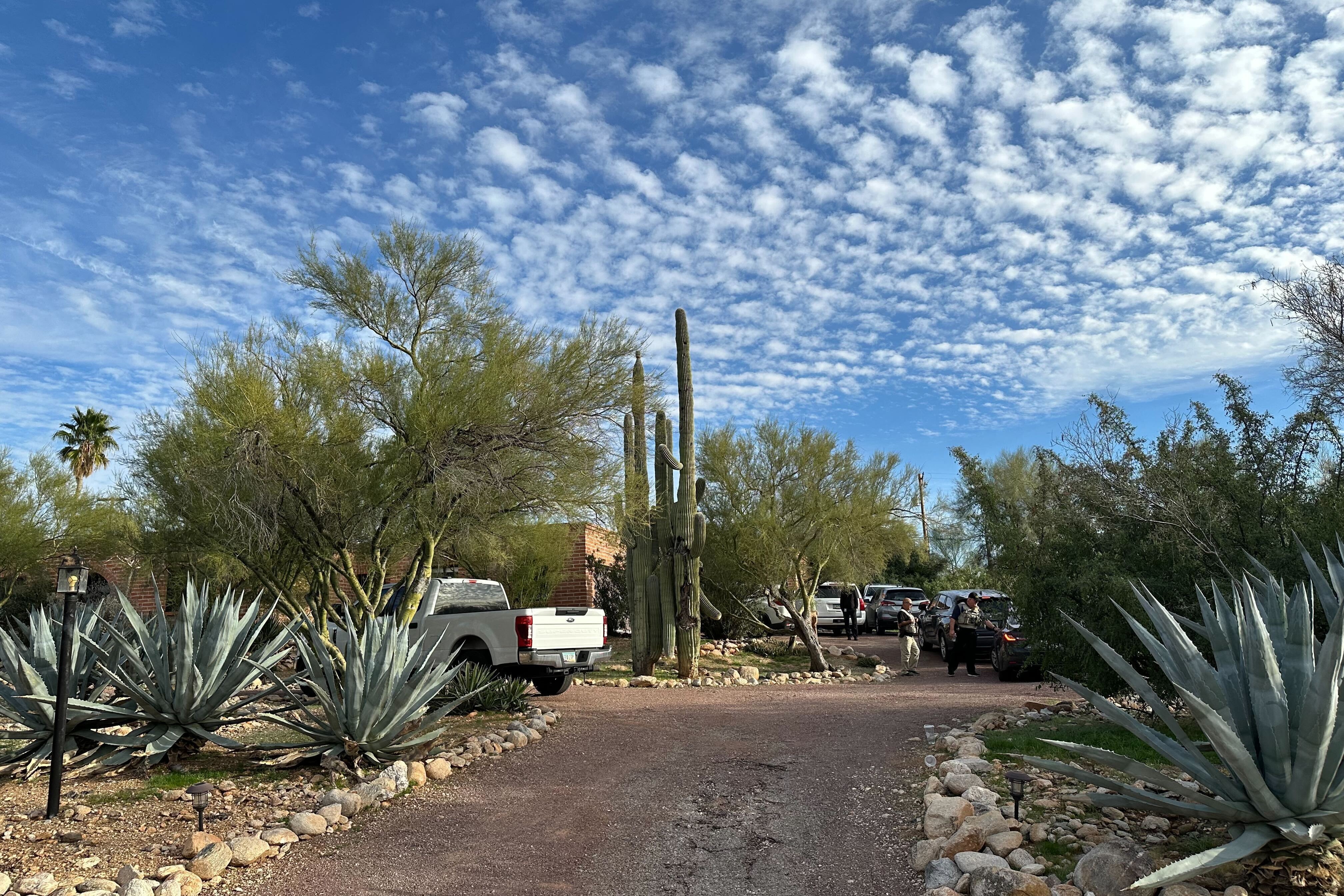 Law enforcement officers are present outside the home of Nancy Guthrie, the mother of "Today" host Savannah Guthrie, near Tucson