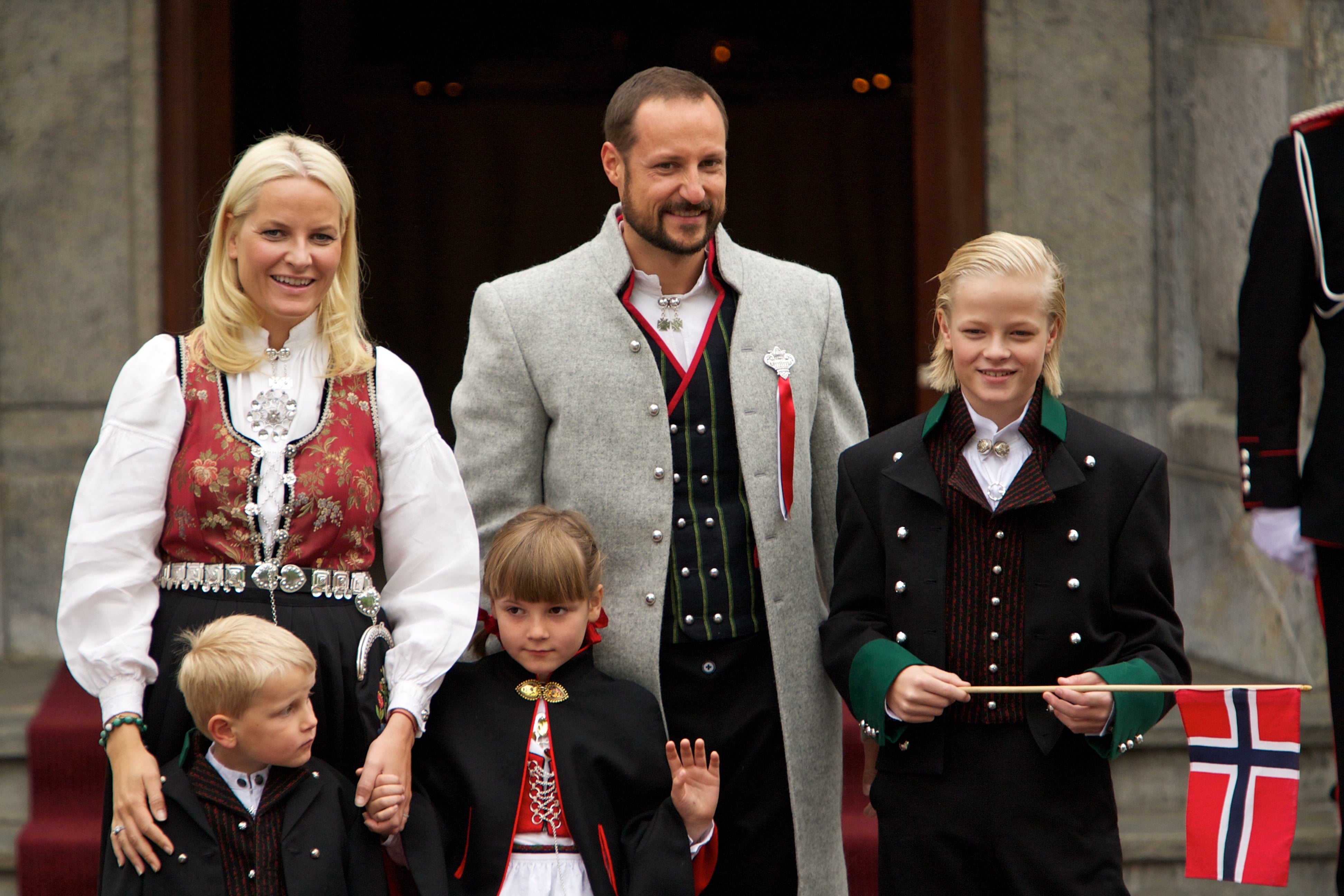 Crown Princess Mette-Marit Tjessem Høiby (left), with husband Crown Prince Haakon (middle), and Marius (right) in 2011. Also pictured are Prince Sverre Magnus (front left) and Princess Ingrid Alexandra (front middle).