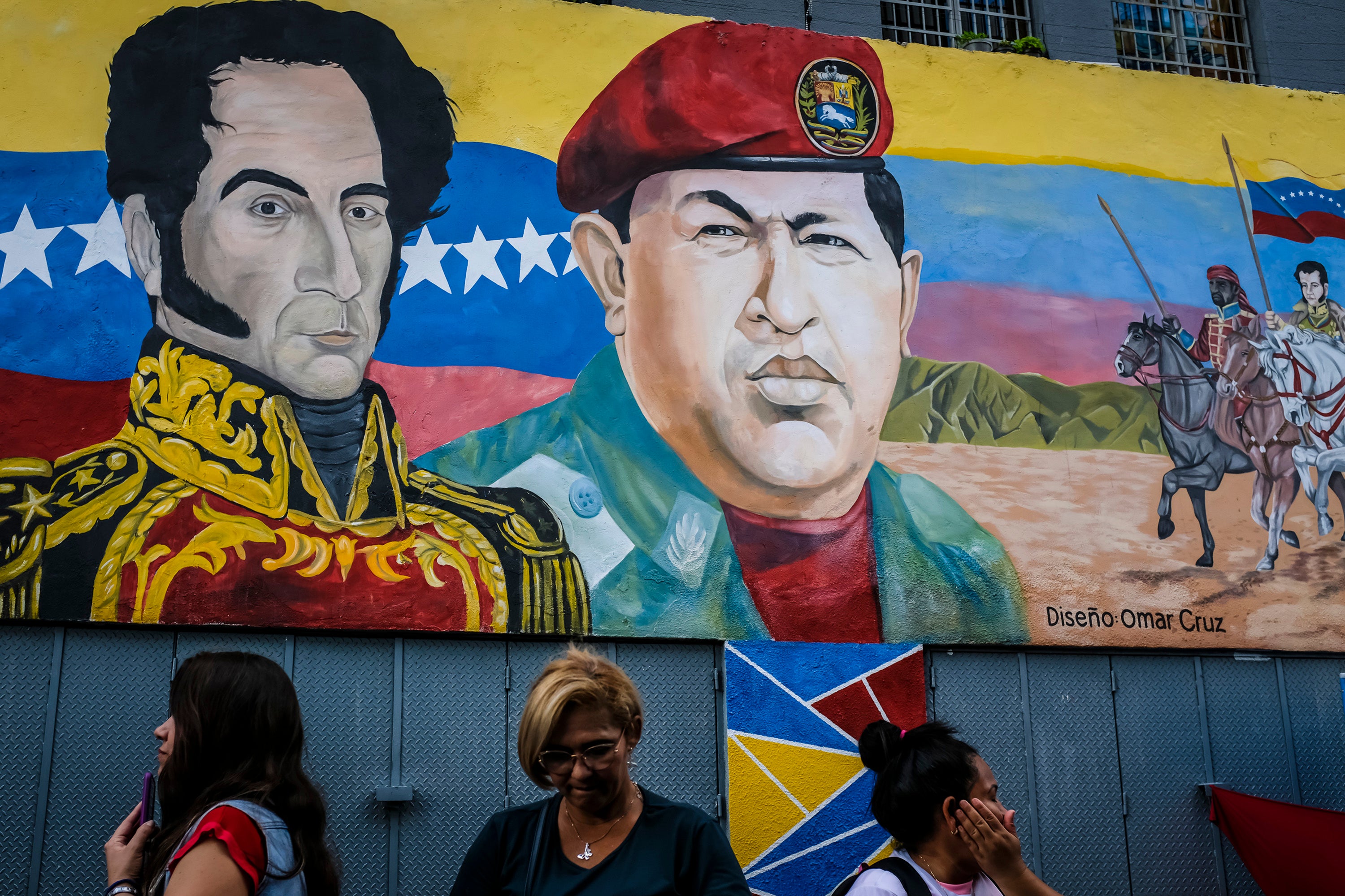 A mural of Simon Bolivar, left, and former Venezuelan president Hugo Chavez in Caracas