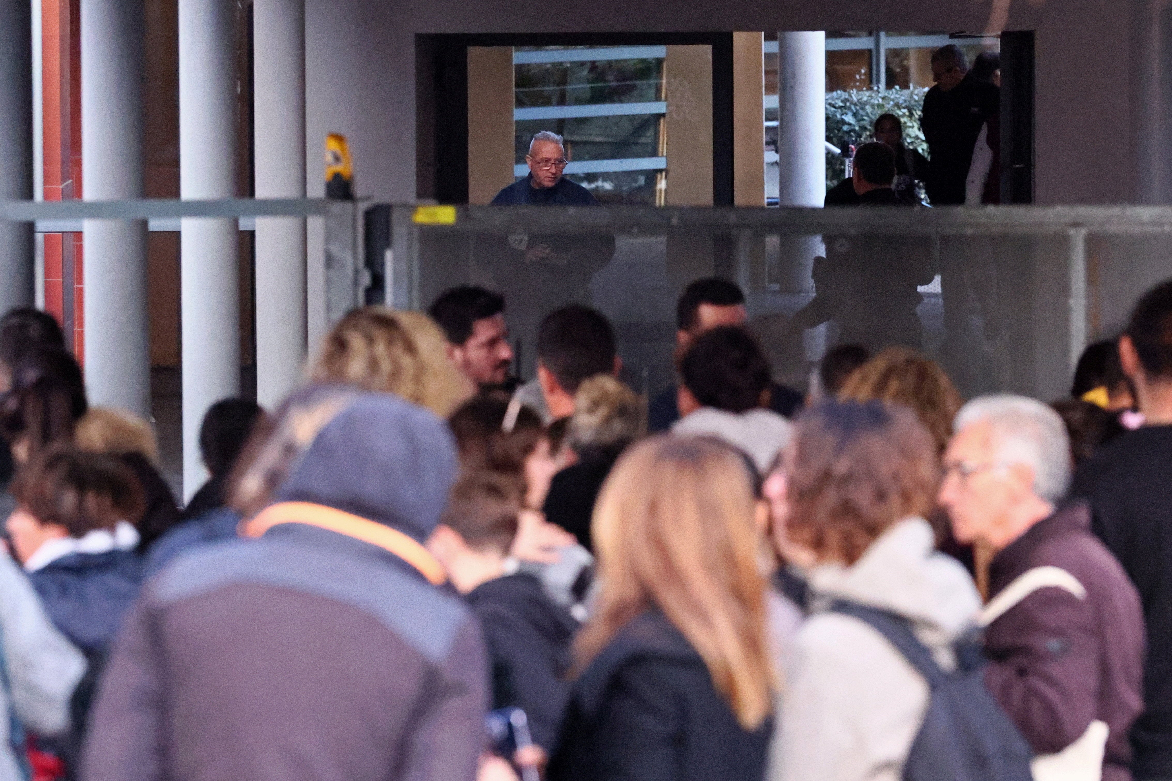 Students and parents gather outside the school following the incident