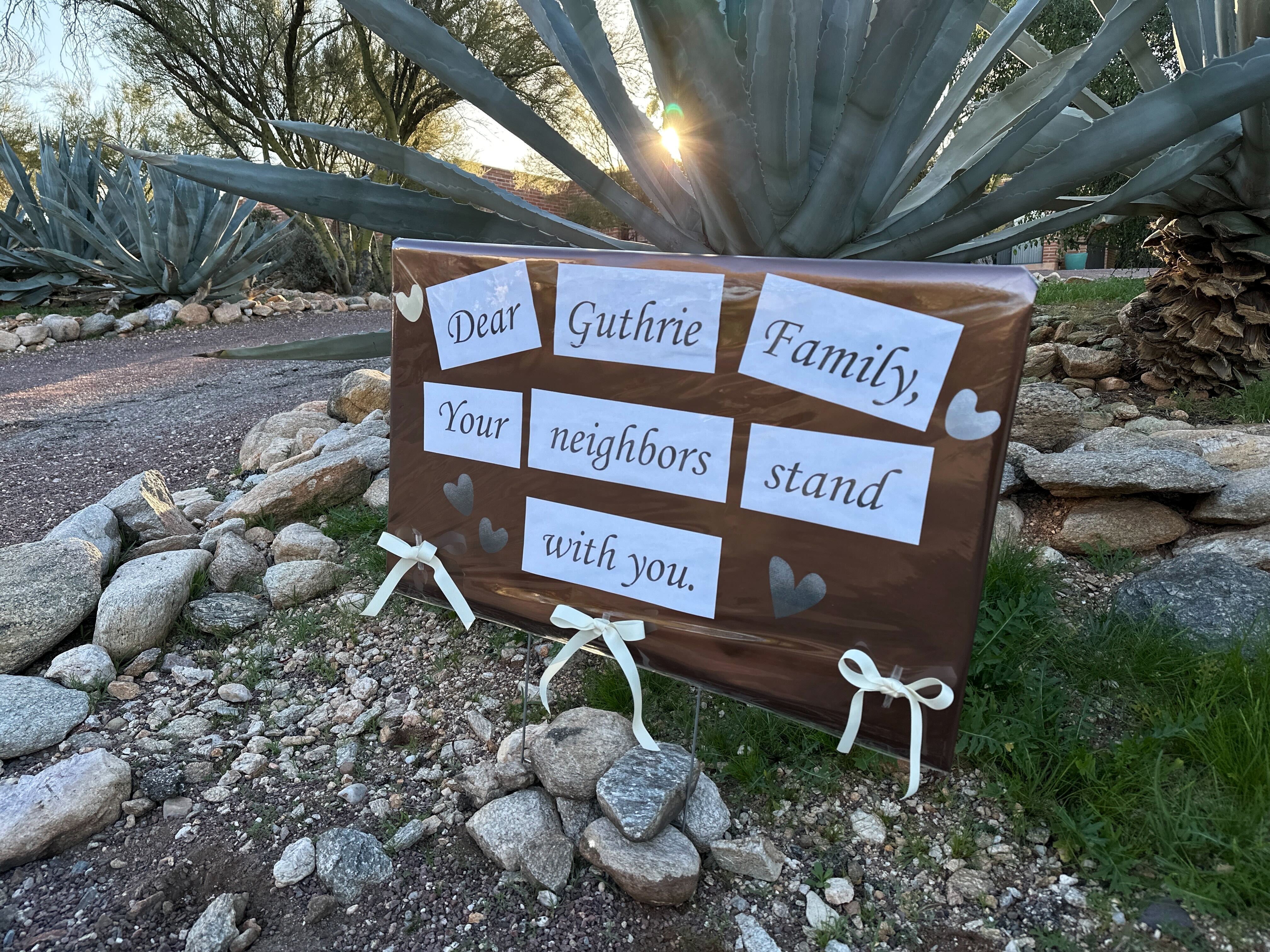 Nancy Guthrie's neighbors show support with a handmade sign near her home