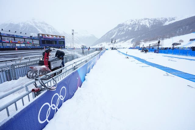 <p>A worker blows snow off a path at the 2026 Winter Olympics, in Livigno, Italy.</p>