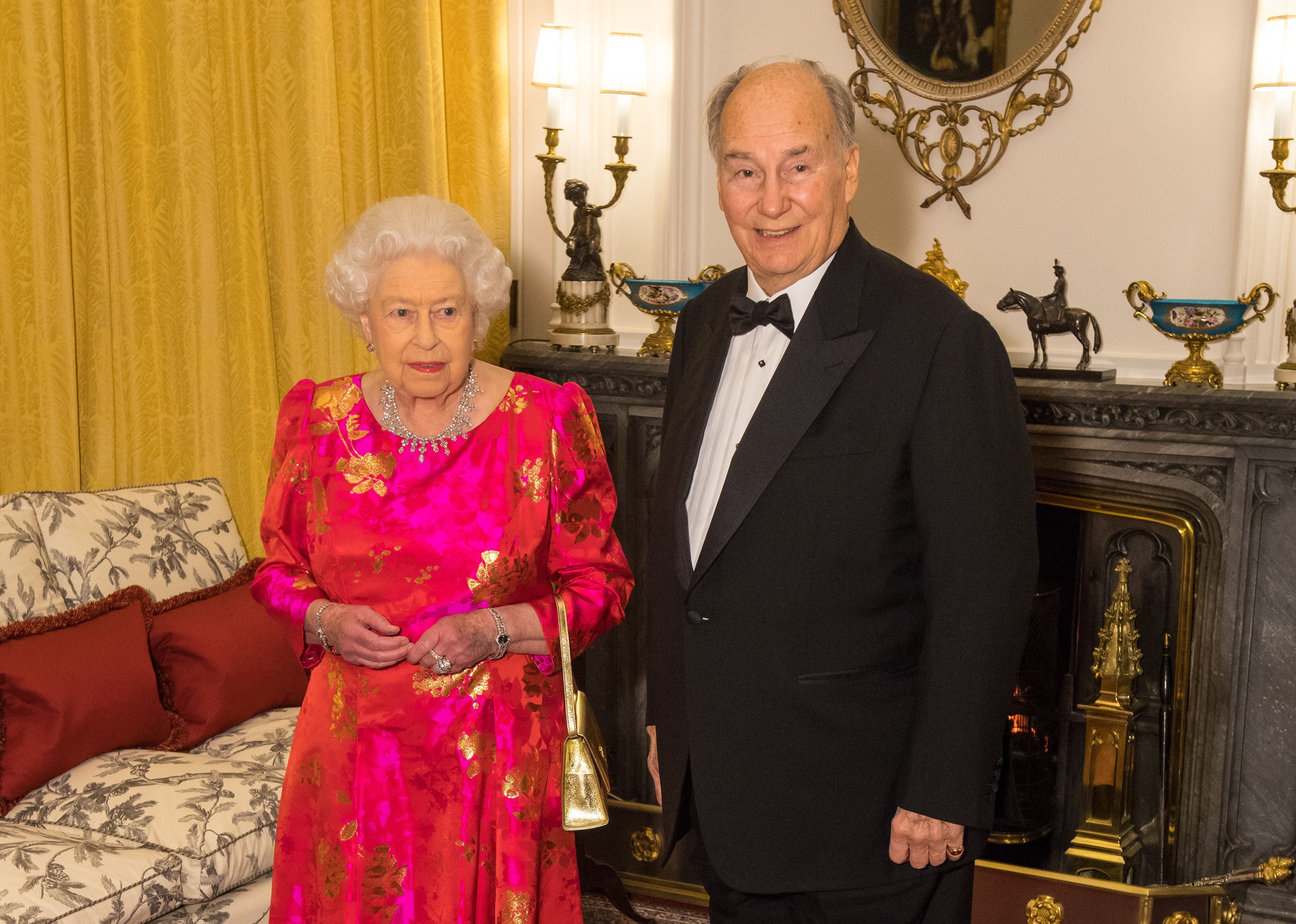 Queen Elizabeth II hosting a reception for the late Aga Khan IV in the White Drawing Room at Windsor Castle