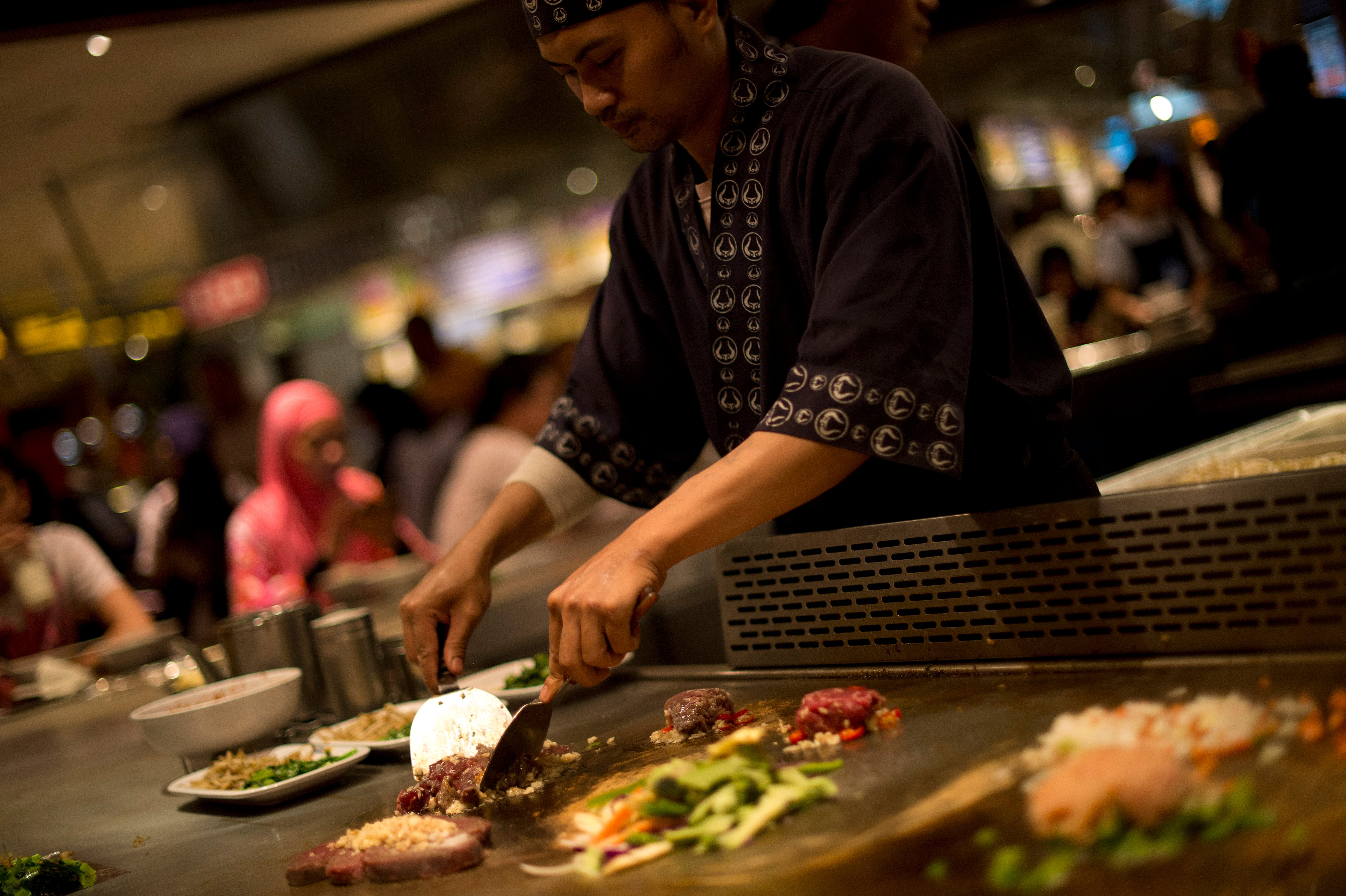 <p>File photo. A chef prepares dishes for his customers at a restaurant in Kuala Lumpur</p>