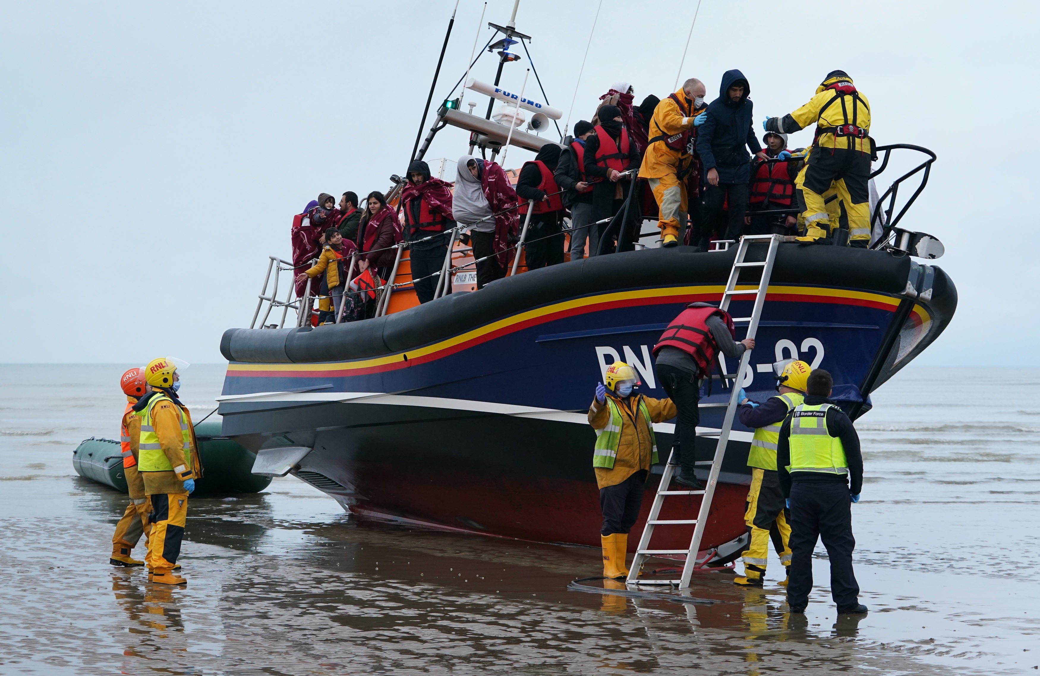 A group of people thought to be migrants are brought in to Dungeness, Kent, by the RNLI following a small boat incident in the Channel on November 20, 2021.
