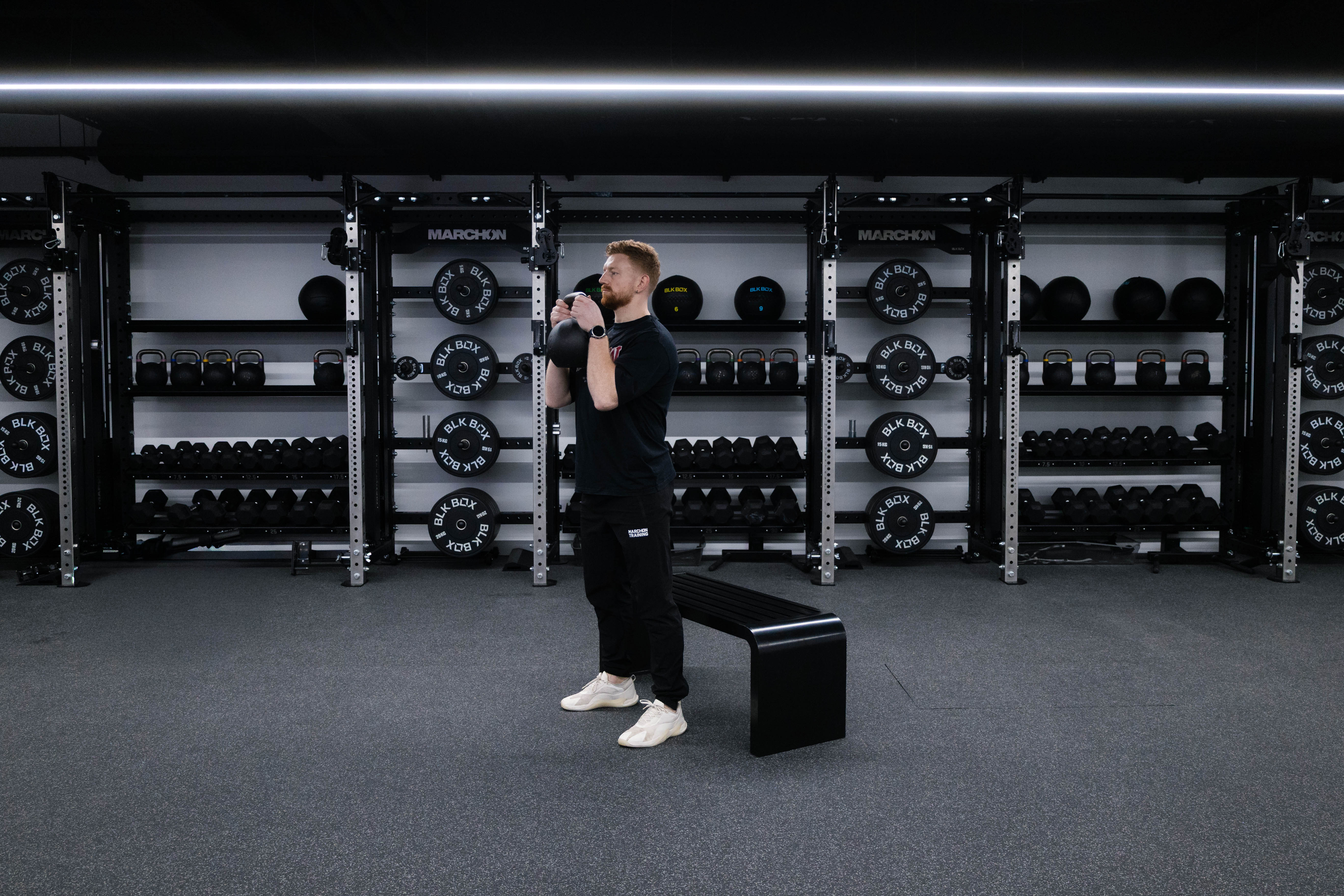 Marchon coach Patrick James demonstrates how to perform a squat to box